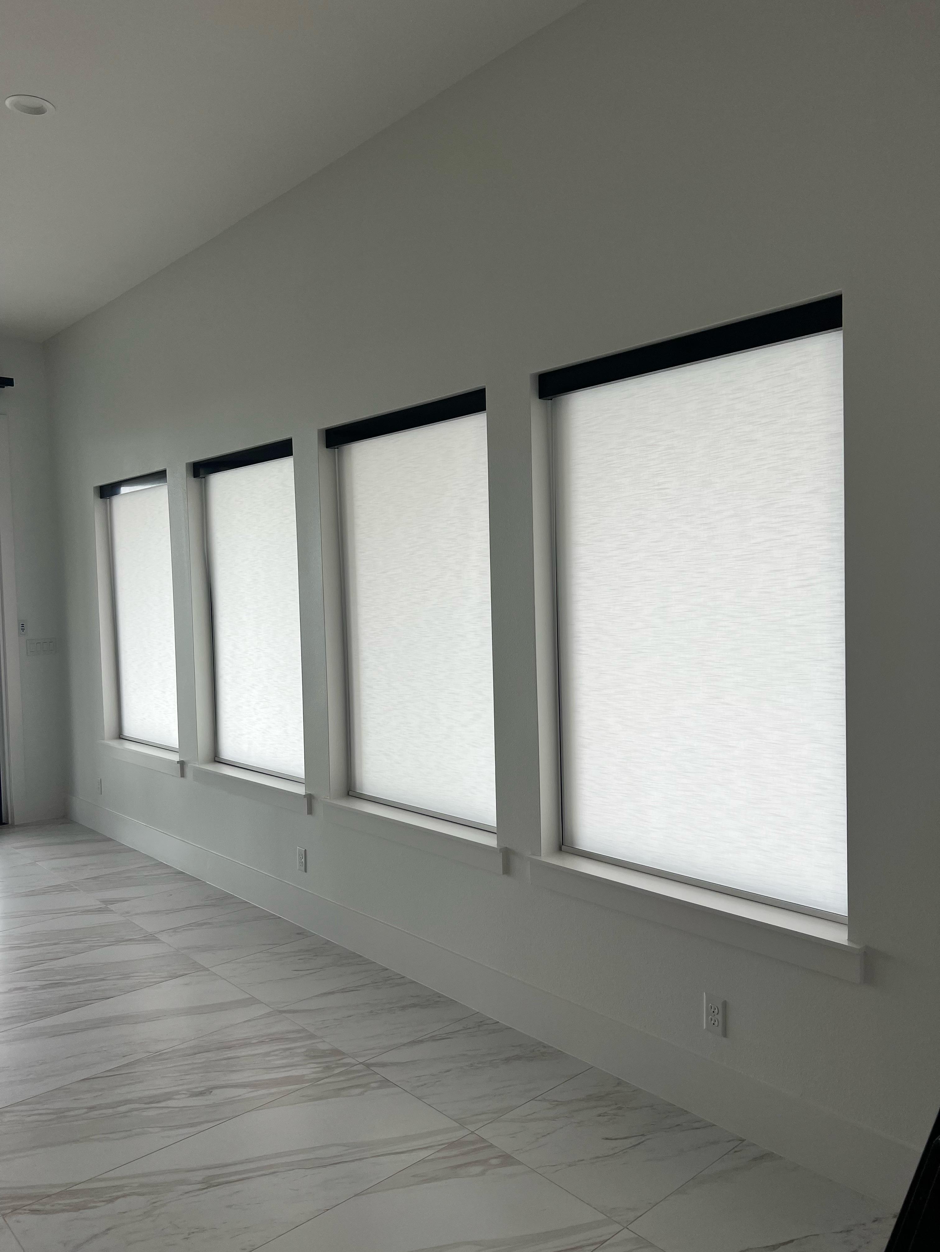 Black and white is totally in right now! We installed white cordless roller shades with a black valance in our client's media room in Fate, TX. Our team at Budget Blinds of Rockwall, Terrell, and Greenville love making our client's dream home a reality!