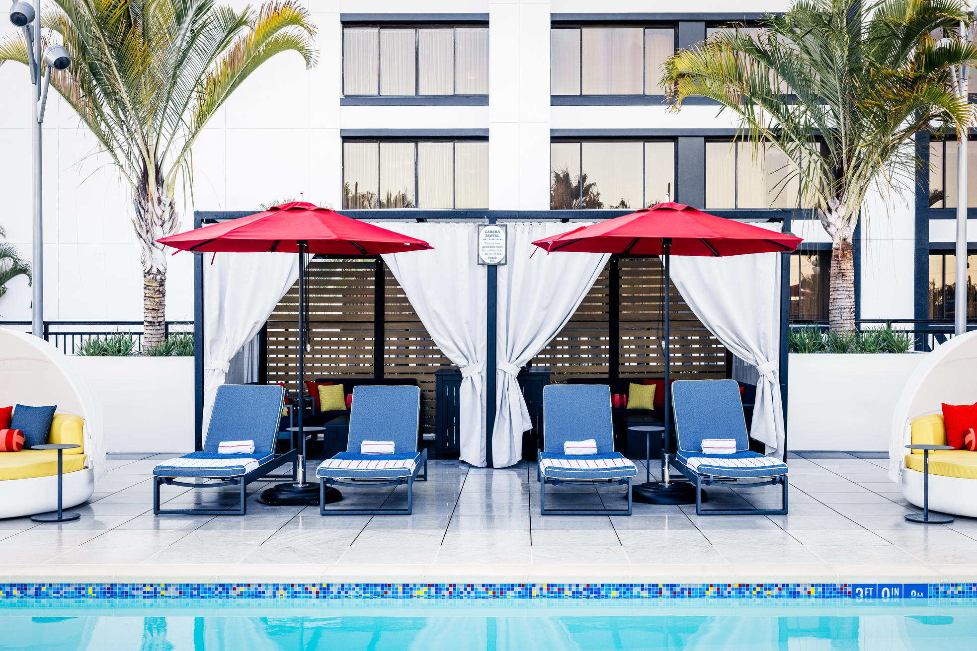 Pixar Place Hotel at Disneyland Resort Pixel pool cabana with lounge chairs and umbrellas