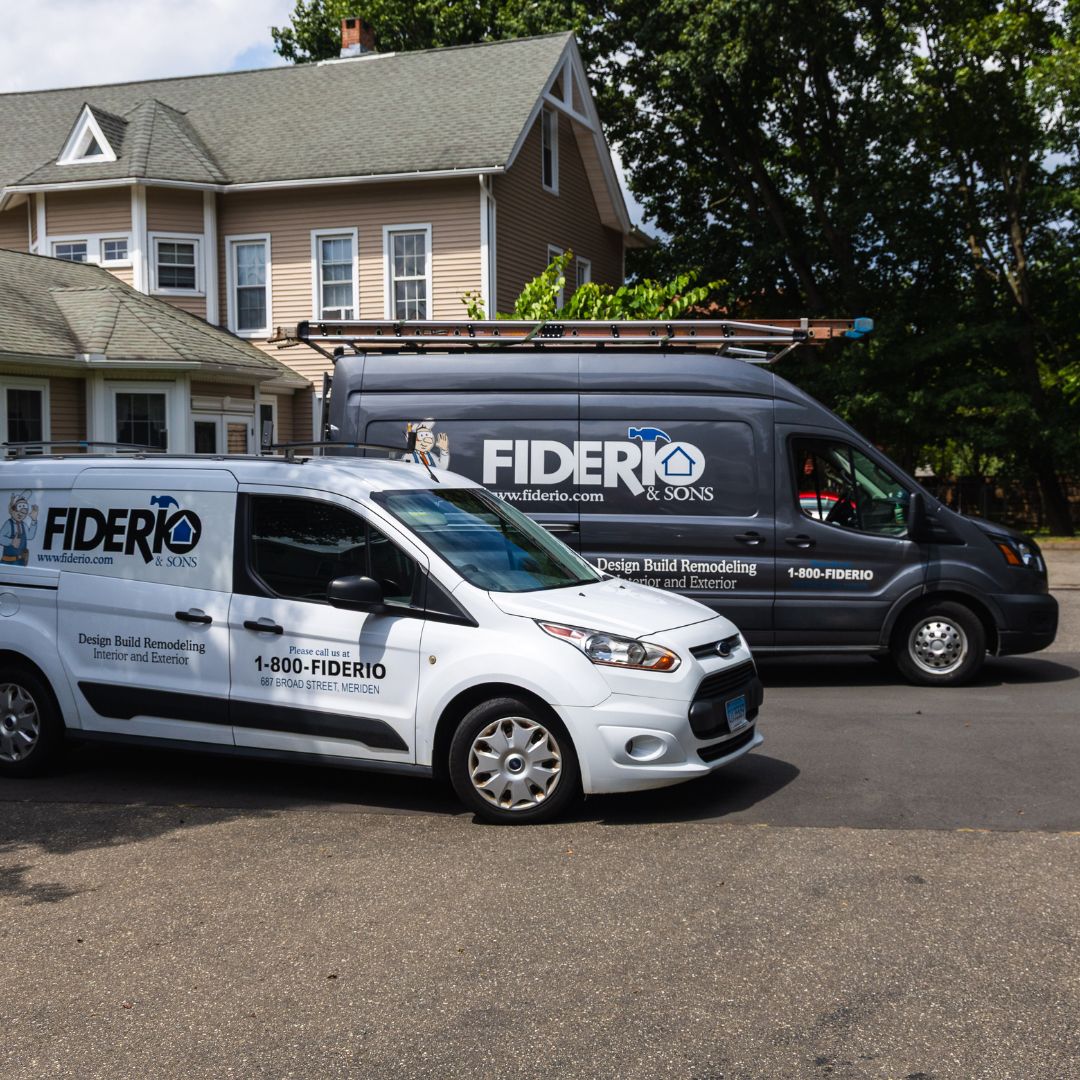Branded Fiderio & Sons service vans parked at headquarters, ready for field appointments and job site visits.