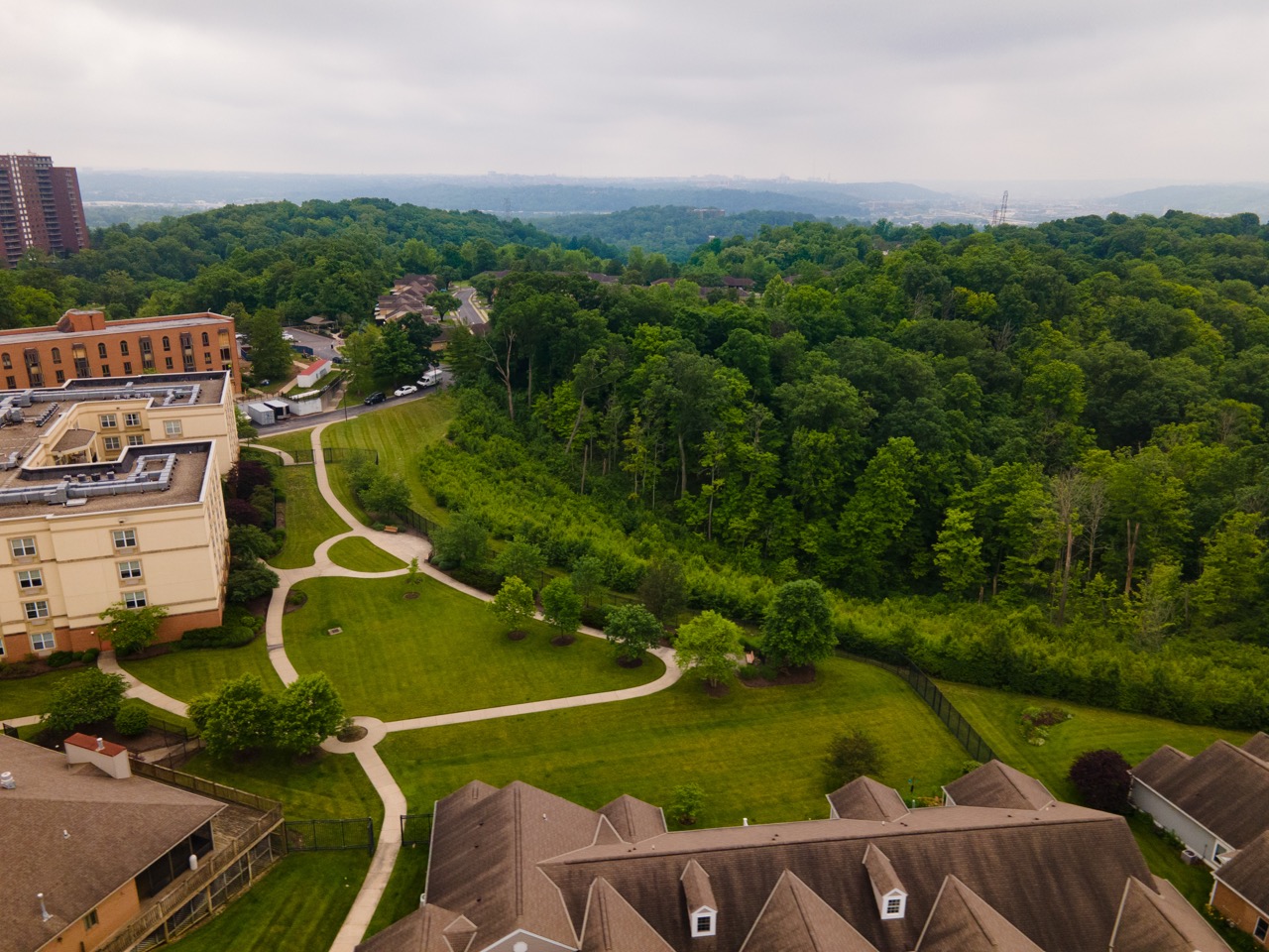 Aerial view of the Twin Towers Senior Living Community campus, with walking paths and neatly manicured lawns.