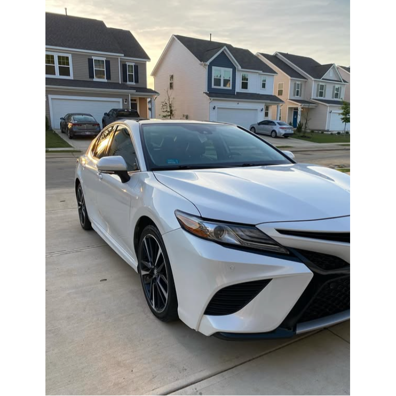 Freshly detailed white Toyota Camry with a clean exterior, glossy paint, spotless wheels, and a shar 