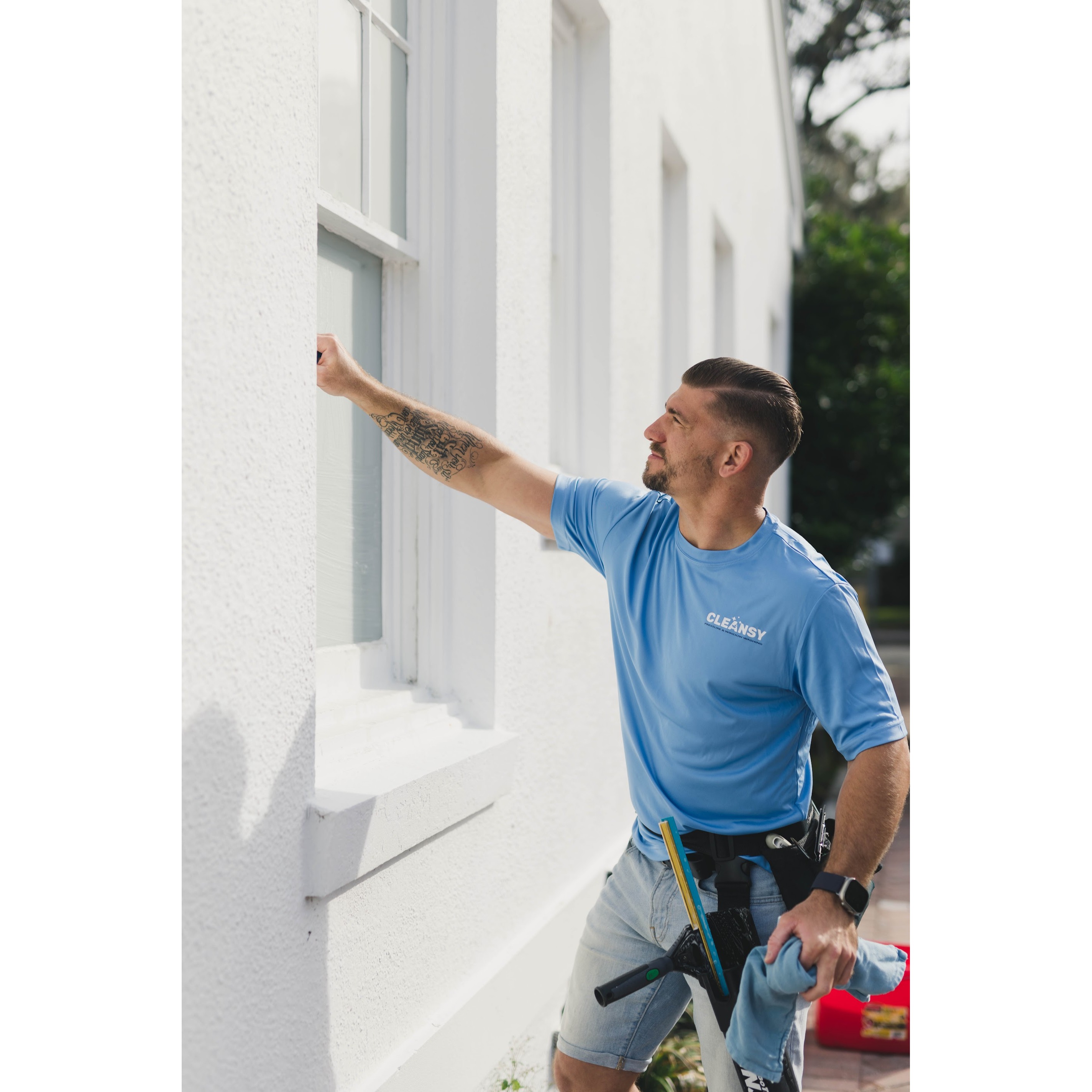 Cleansy team member performing professional window and exterior cleaning to help keep properties cle 