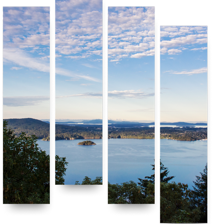A peaceful lake and surrounding natural landscape on a partly sunny day.
