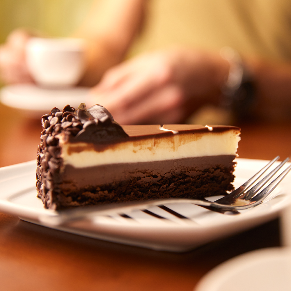 Rich layers of chocolate cake, dark chocolate cheesecake and creamy custard mousse.