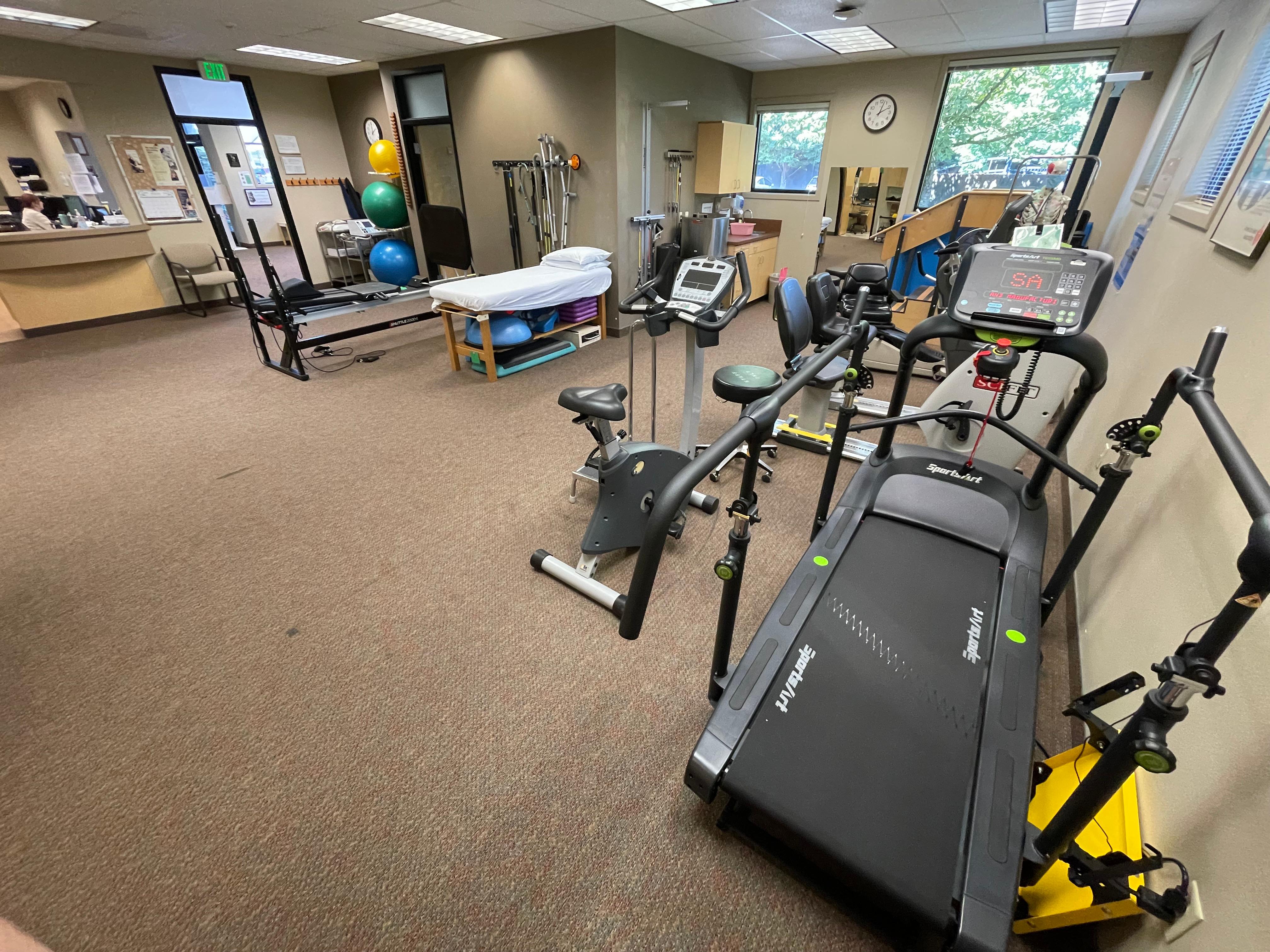 Physical therapy room with rehab equipment.