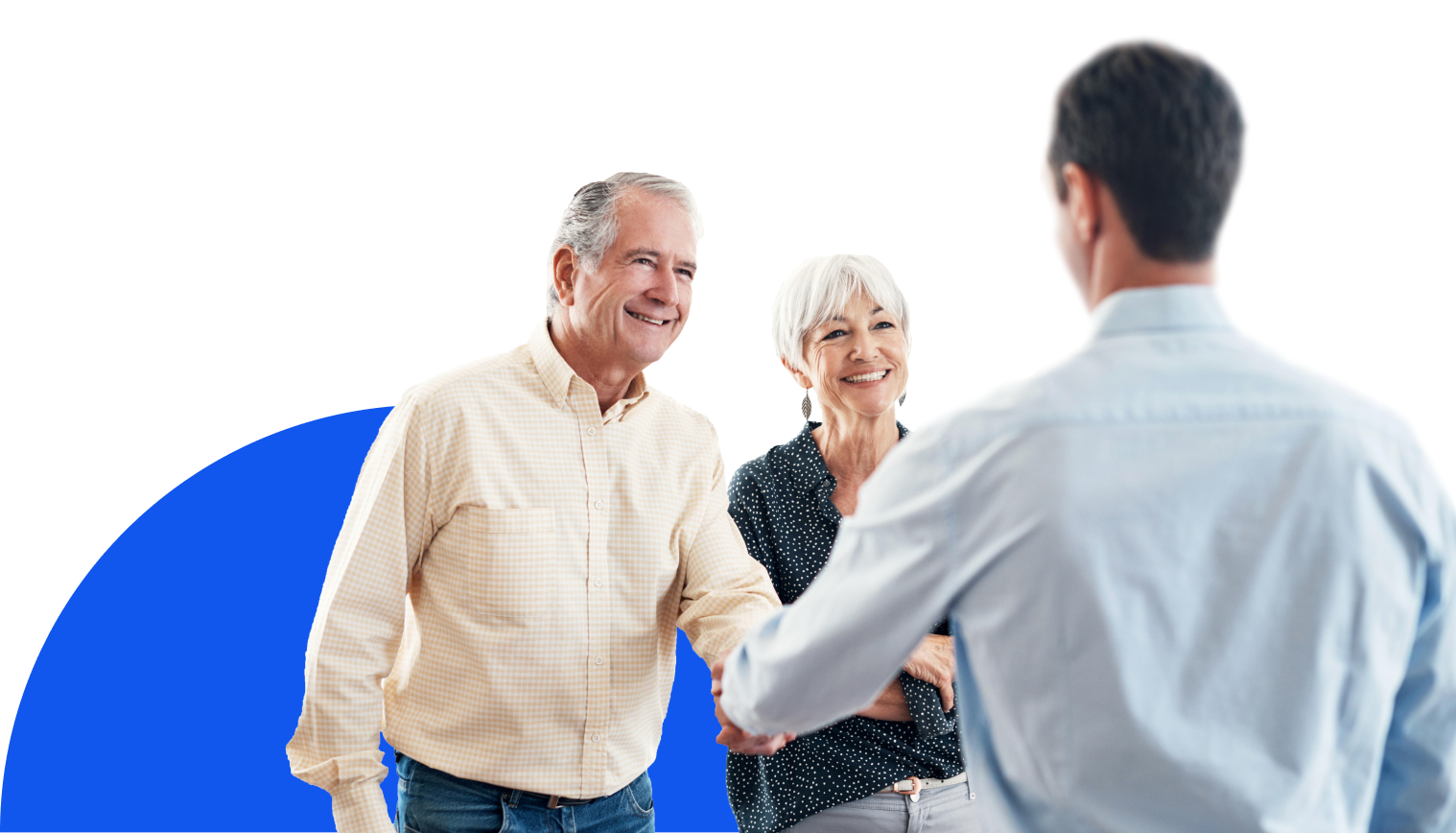 A man in a light blue dress shirt is shaking hands with an older man in a checkered beige shirt. An older woman with short, gray hair, wearing a dark patterned blouse, stands next to the older man and smiles. A large blue semi-circle shape is visible in the lower left corner, and the background is black. The image appears to be a professional stock photo.