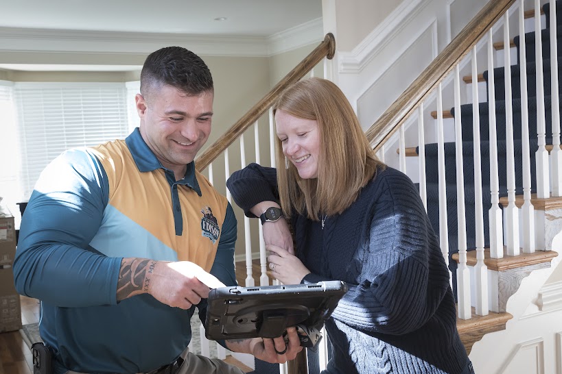 Thomas Edison Electric technician discussing electrical service details with homeowner inside residential property in Pennsylvania