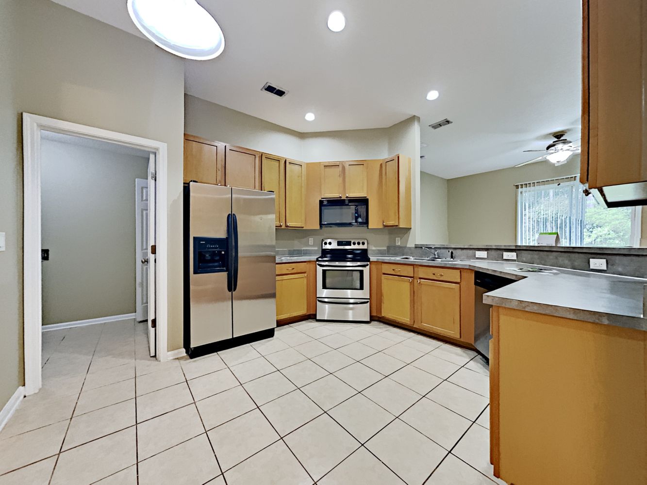 Spacious kitchen with stainless steel appliances at Invitation Homes Jacksonville.