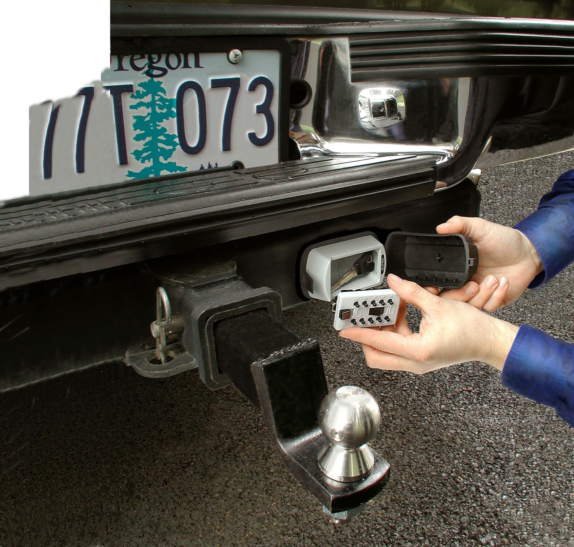 Image of a person putting a key in a key safe.