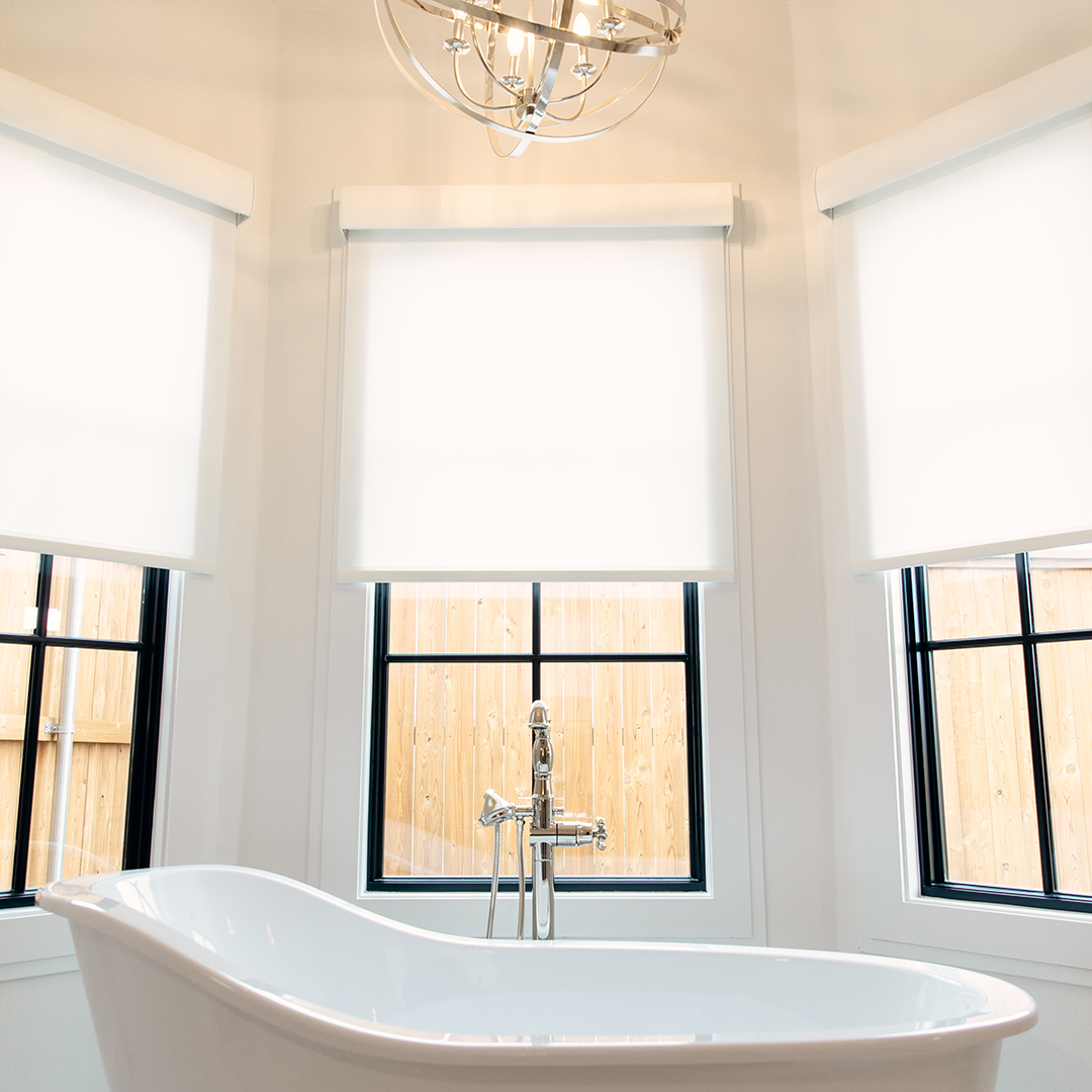 Simple and elegant roller shades complete this Primary Suite oasis.