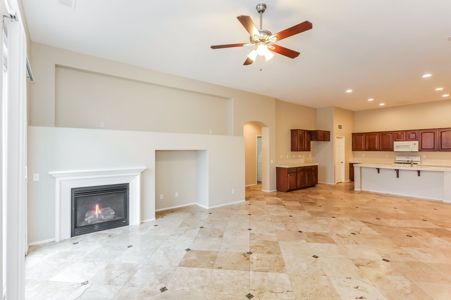 Livng area with fireplace and open kitchen at Invitation Homes Southern California.