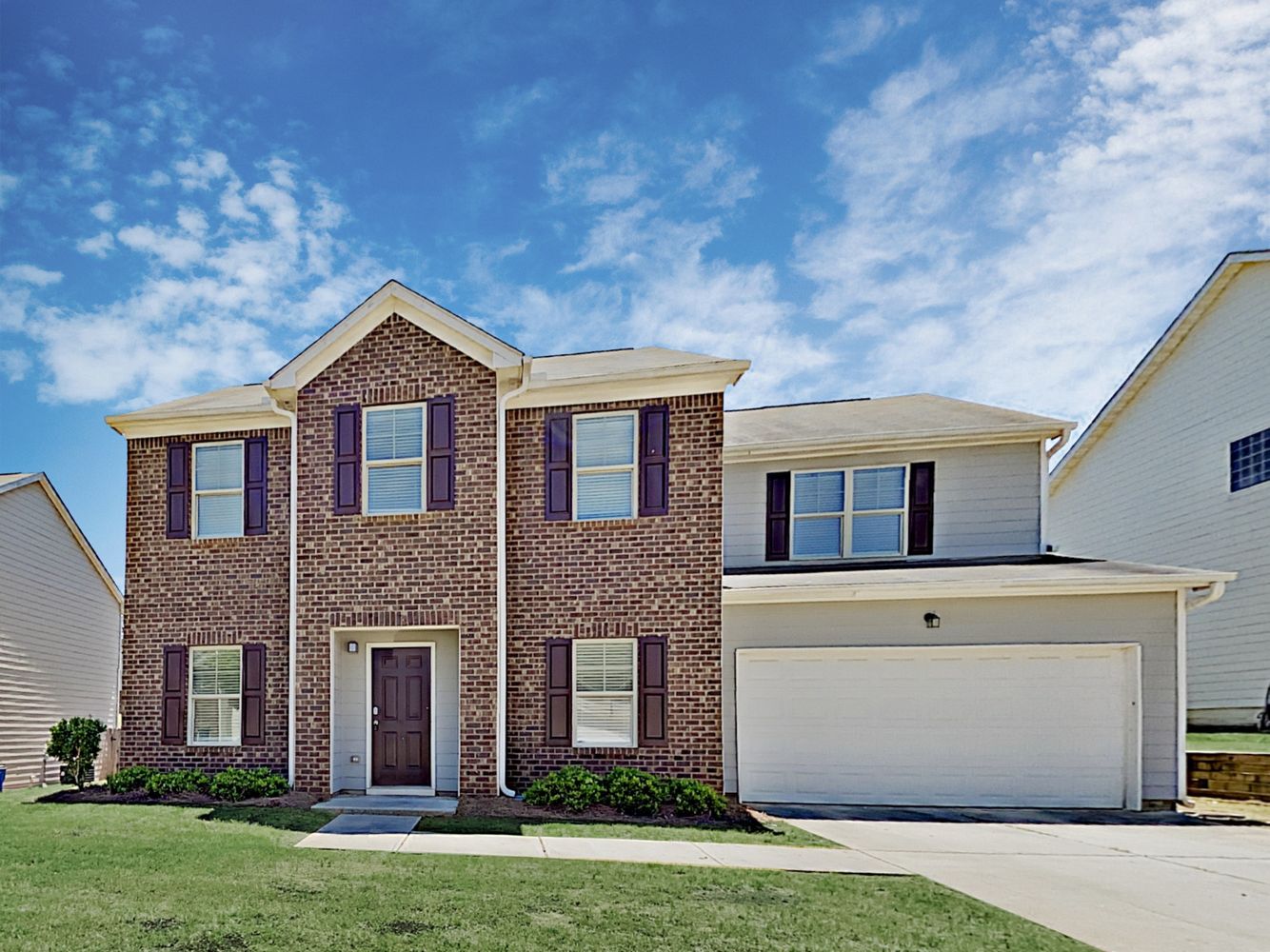 Stunning brick home with a two-car garage at Invitation Homes Atlanta.