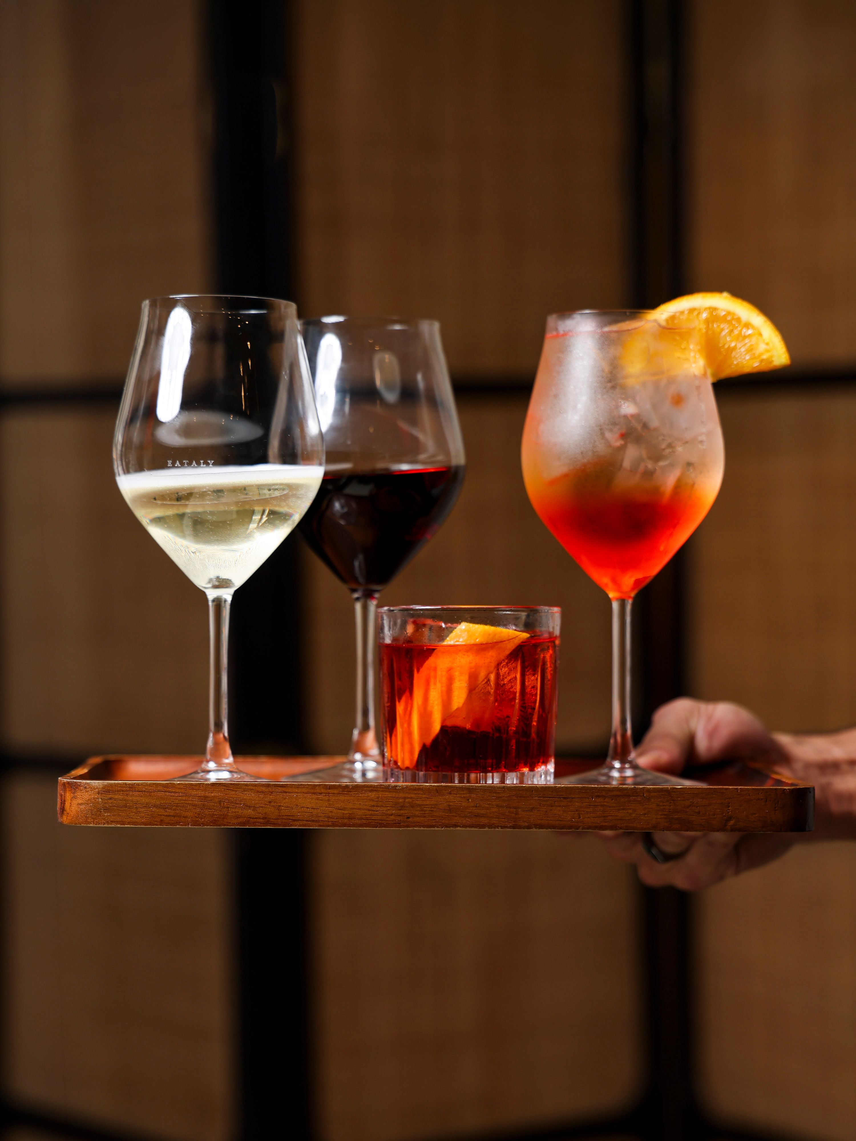 Tray with glasses of our Italian wine selection and classic Italian cocktails