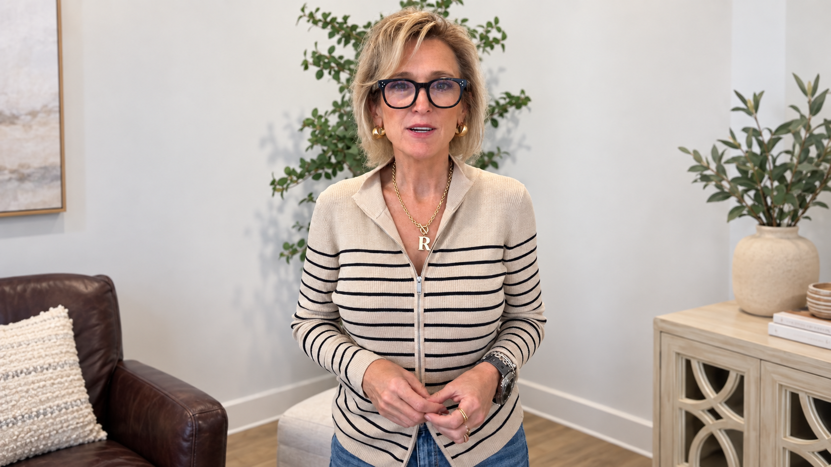 A model wears a soft J.A.K. striped zip top with Flying Monkey wide-leg jeans and a personalized charm necklace at Monogramme No. 29, creating an easy, polished look for comfortable everyday style.