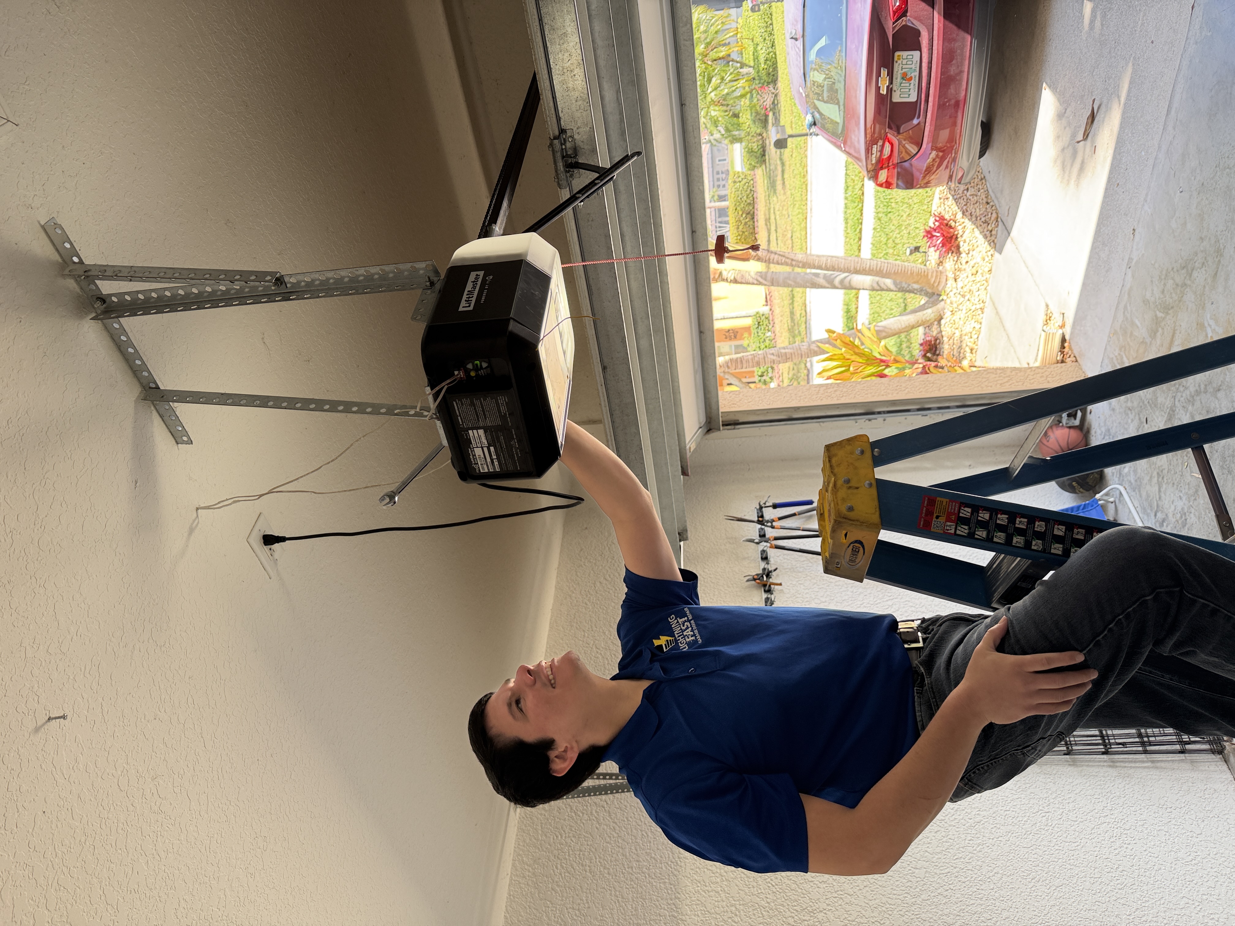 Ken inspecting a garage door opener in Fort Myers