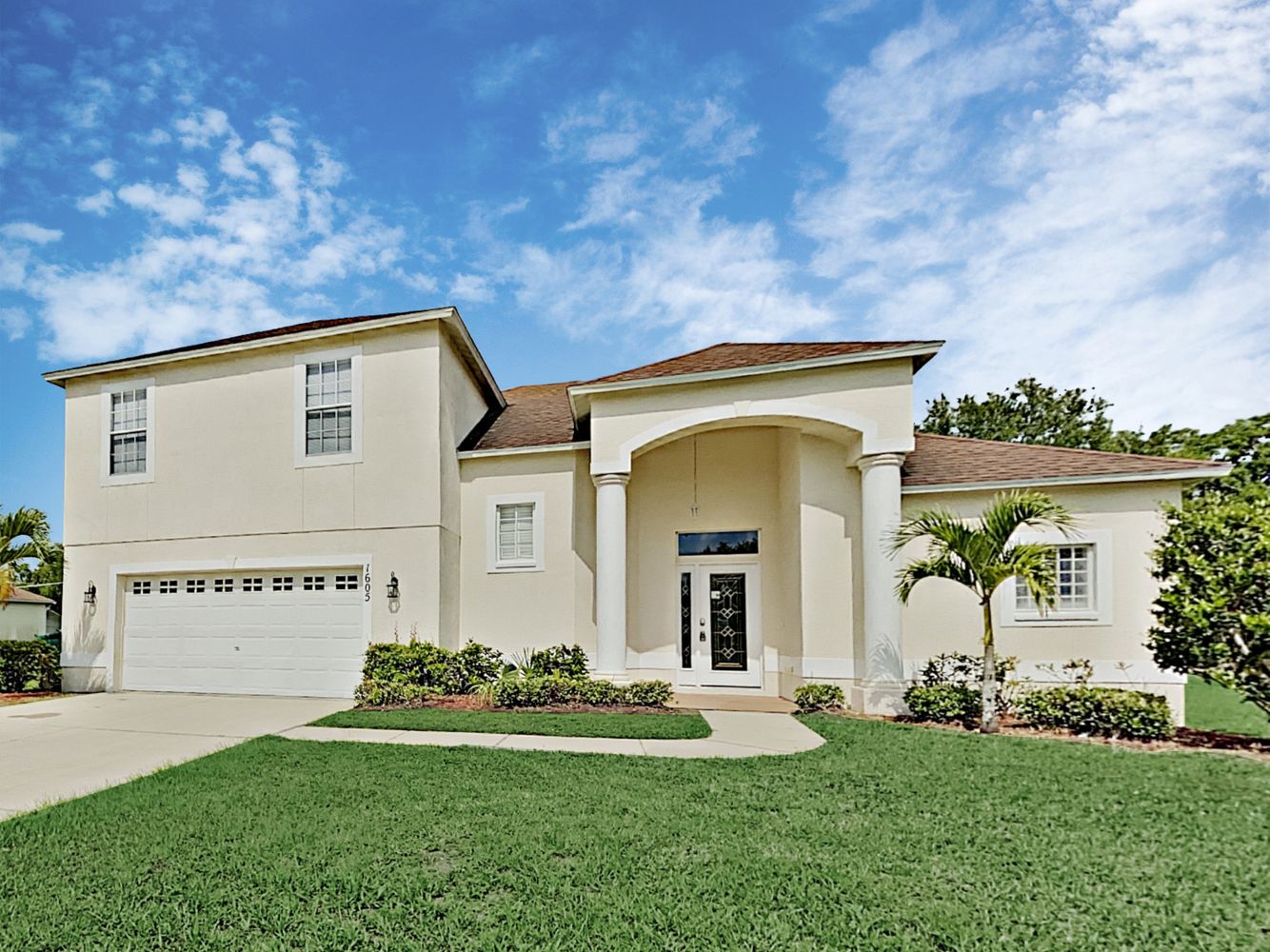 Front of home with driveway and two-care garage at Invitation Homes Tampa.