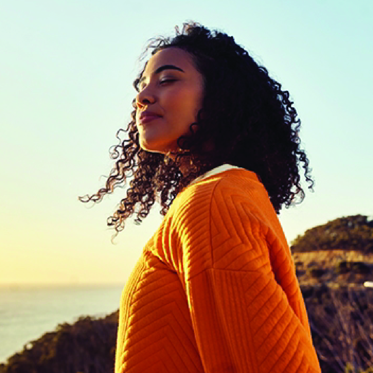 Woman is thinking about AudioNova's solutions for her tinnitus.