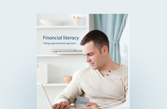 Cover of the financial literacy guide with a young man on his laptop.