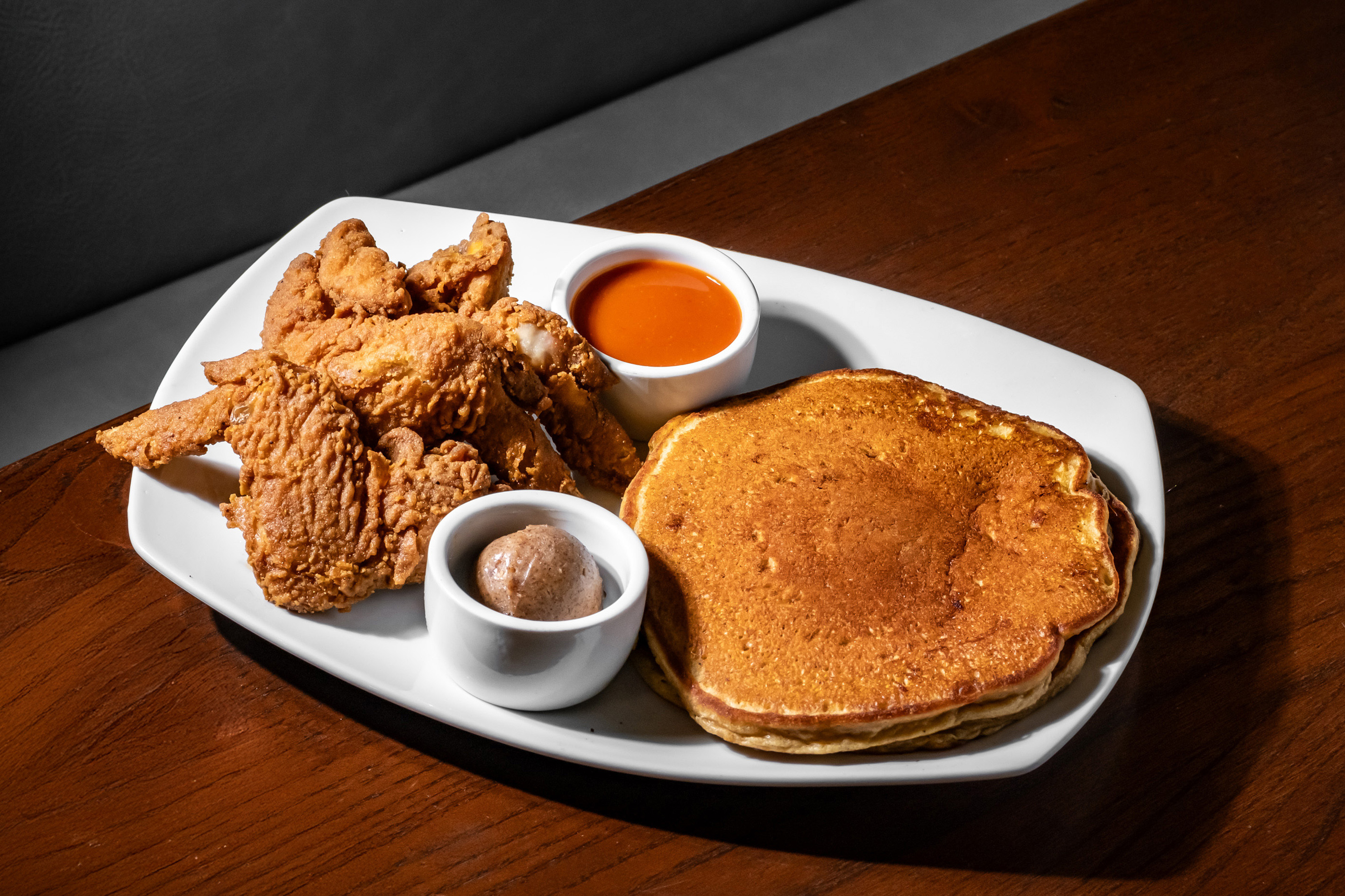 Crispy, flavorful wings served alongside soft, sweet potato pancakes for the perfect sweet and savory combo.