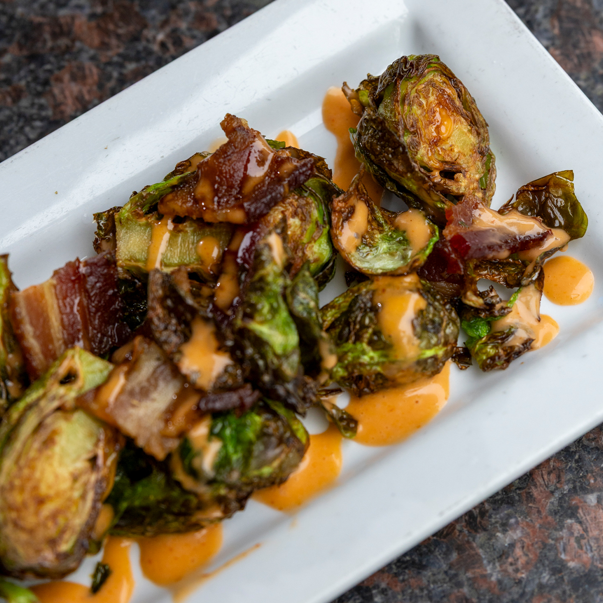 Bacon Brussels Sprouts | applewood smoked bacon, pure honey & sriracha aioli