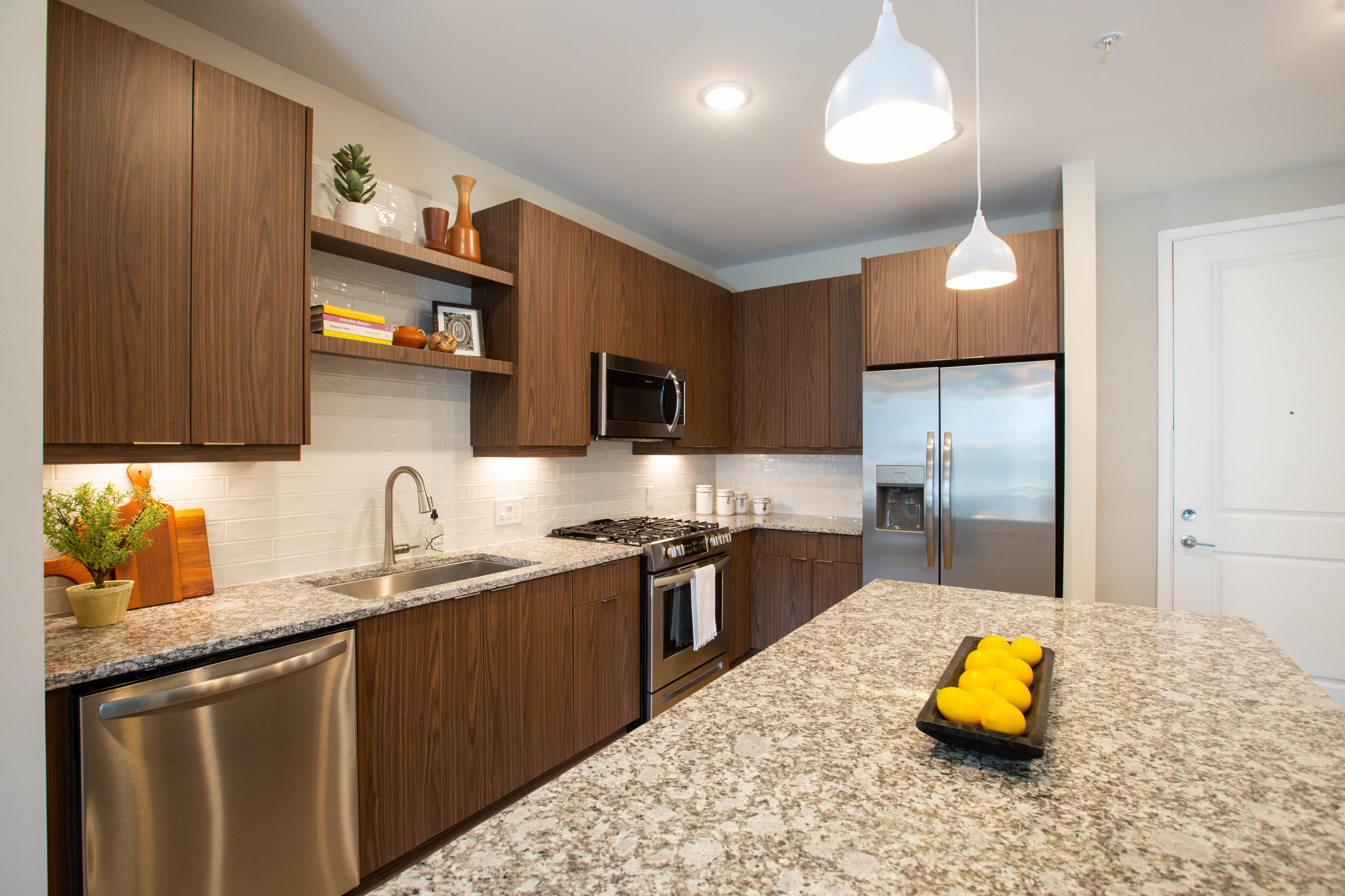 Kitchens with hidden trash and recycling compartments.