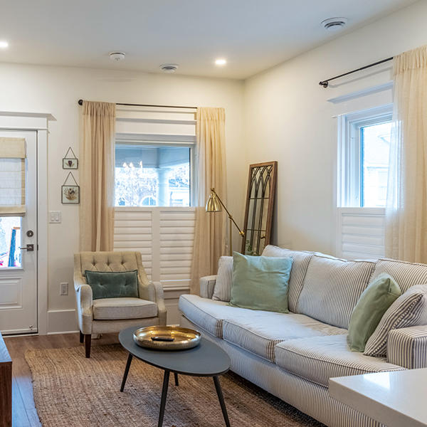 These cafe shutters are a great way to add a bit of privacy while letting light fill this living room. The layered sheer drapes are a nice extra touch that adds elegance and style.