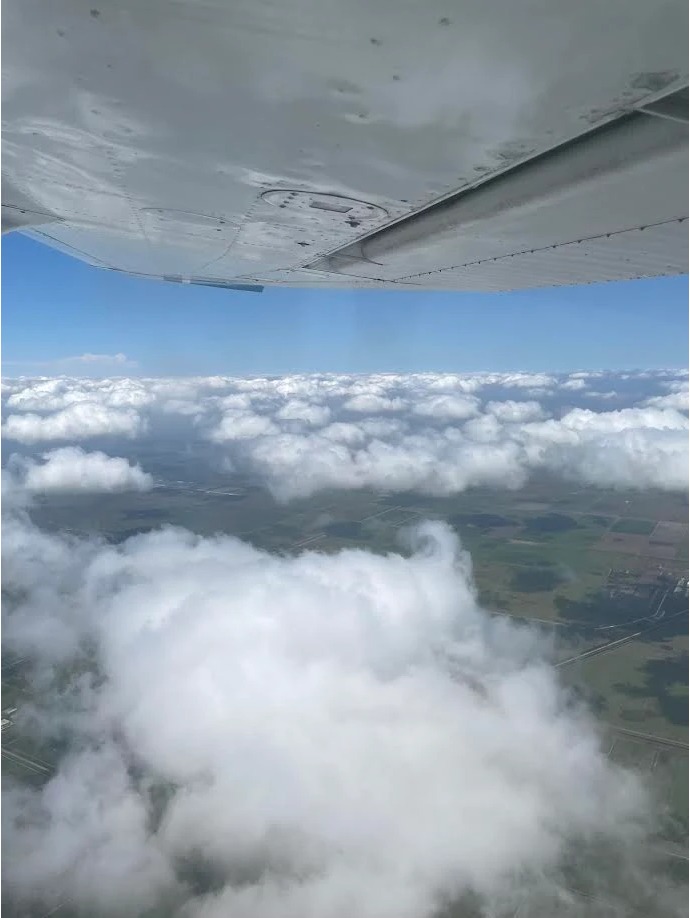 FAA certified flight instructor teaching a student pilot inside the cockpit of a Cessna 172 at 1UP Aviation.
