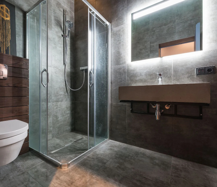 Custom master bathroom remodeling featuring floor-to-ceiling slate grey porcelain tiles, a frameless 