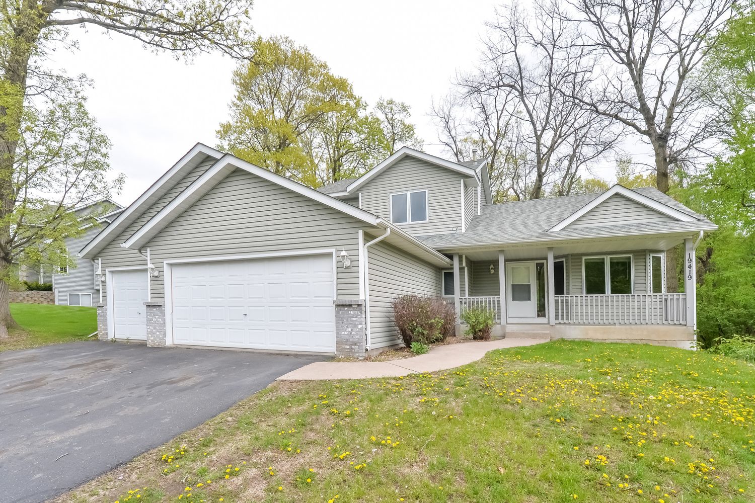 Beautiful home with covered porch and large garage at Invitation Homes Minneapolis.