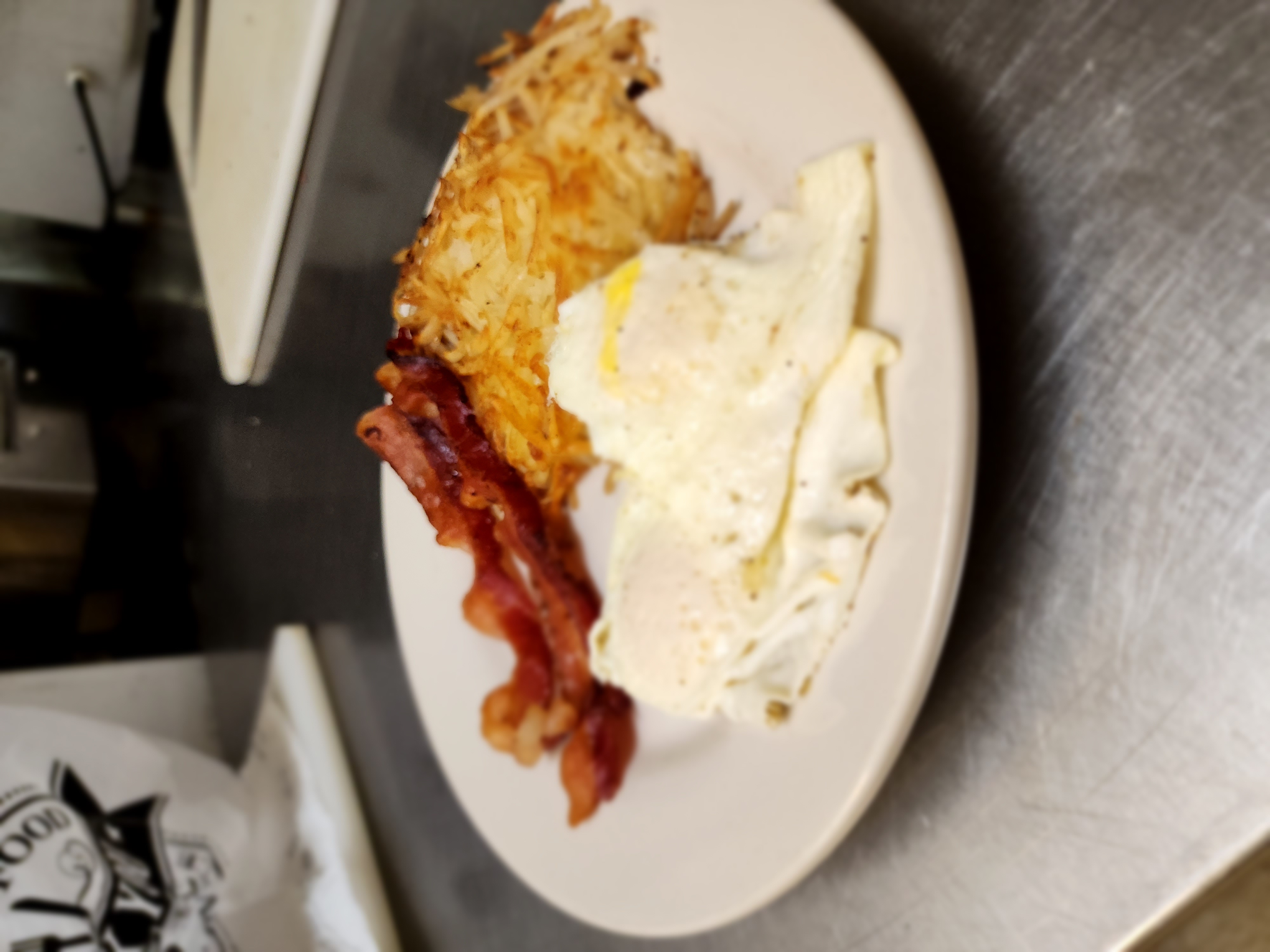 2 eggs any style with 2 slices of bacon, and a hashbrown.