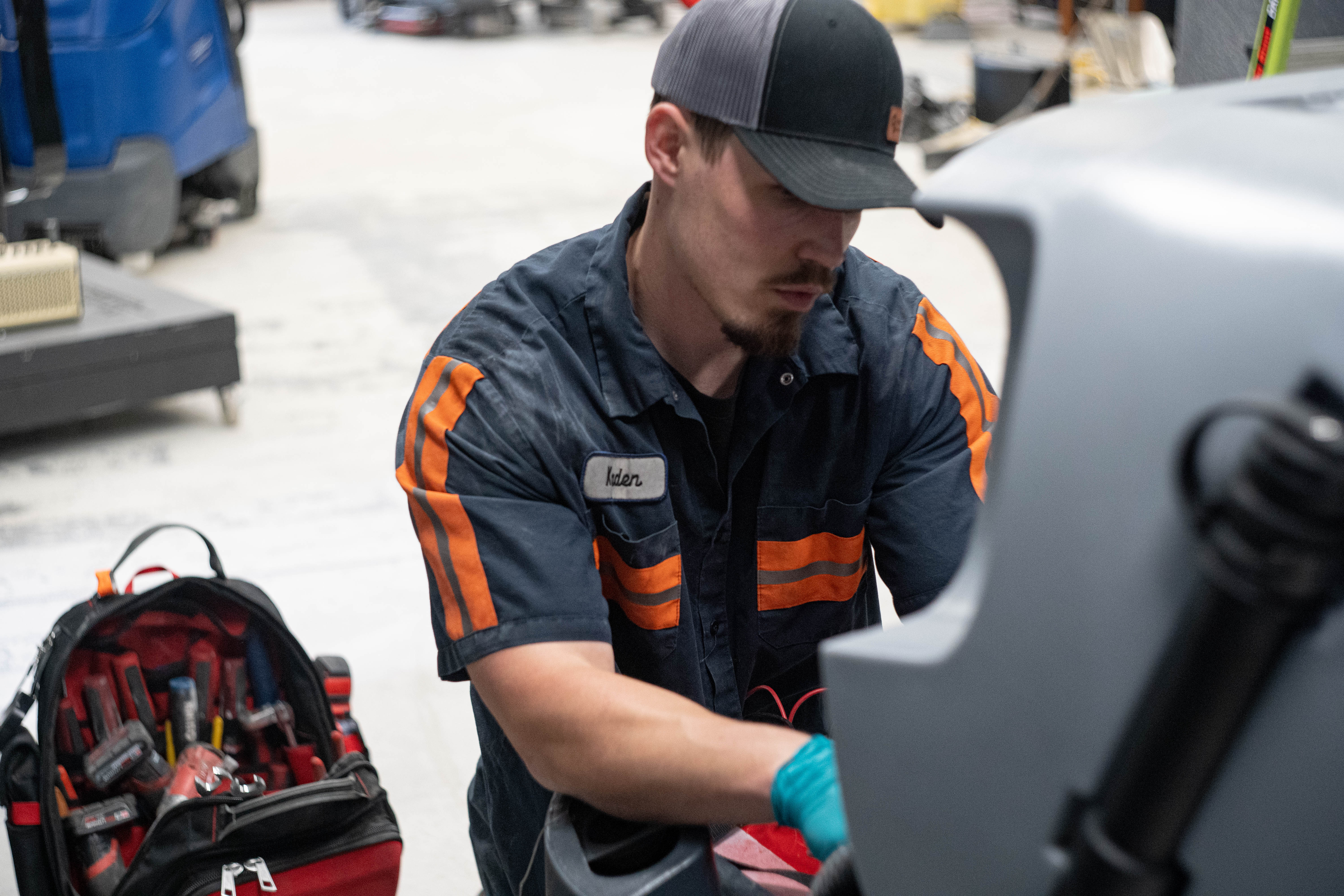 WaySolutions lead technician Kaden works from a fully stocked professional tool bag to perform deep mechanical diagnostics on an Advance floor scrubber. Serving commercial facilities in Layton, Utah, our cross-trained technicians arrive prepared with the exact tools needed to fix your cleaning fleet without unnecessary delays.