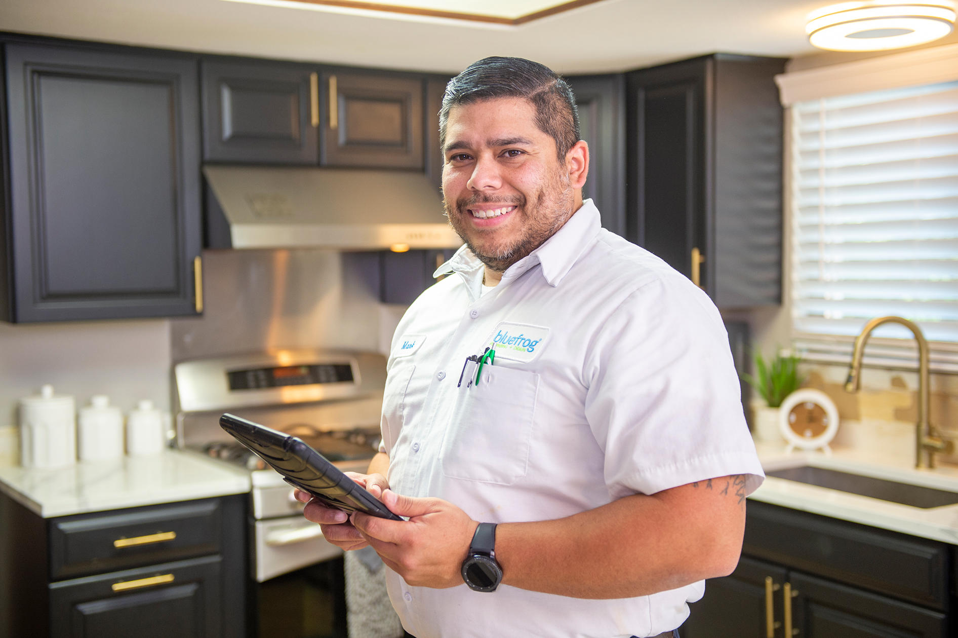 Plumber working in the kitchen. Plumbing Company Serving Katy, Sugar Land, Memorial City, Houston.