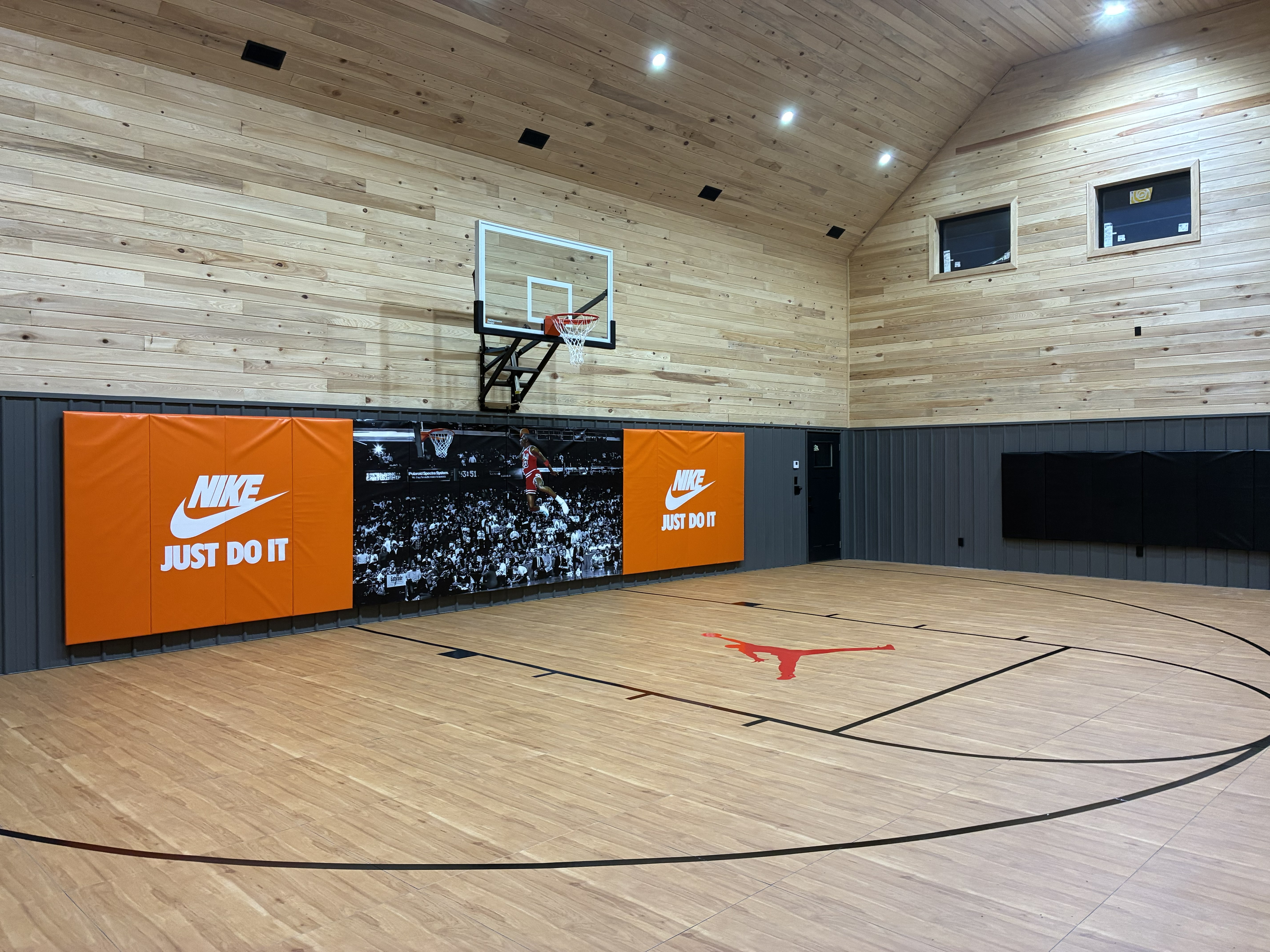 Custom indoor basketball court with Nike branding.