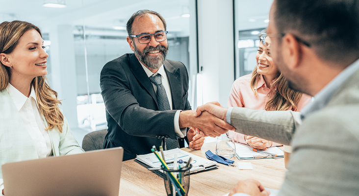 A client shaking hands with their advisor.