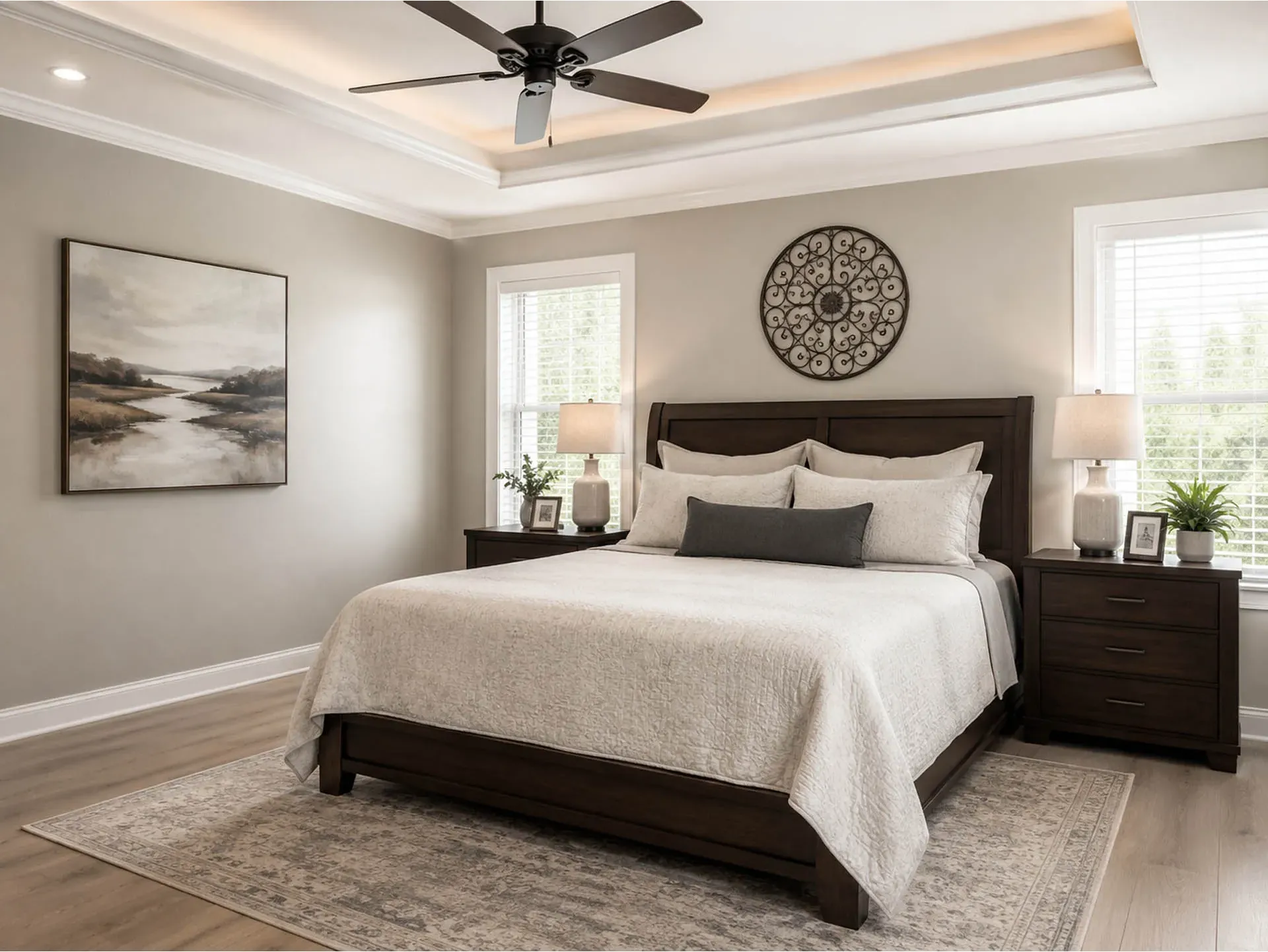 Cozy Modern Main Suite Design: Highlights a bold dark wood sleigh bed, elegant tray ceiling, natural lighting, and a cohesive, calming neutral palette.