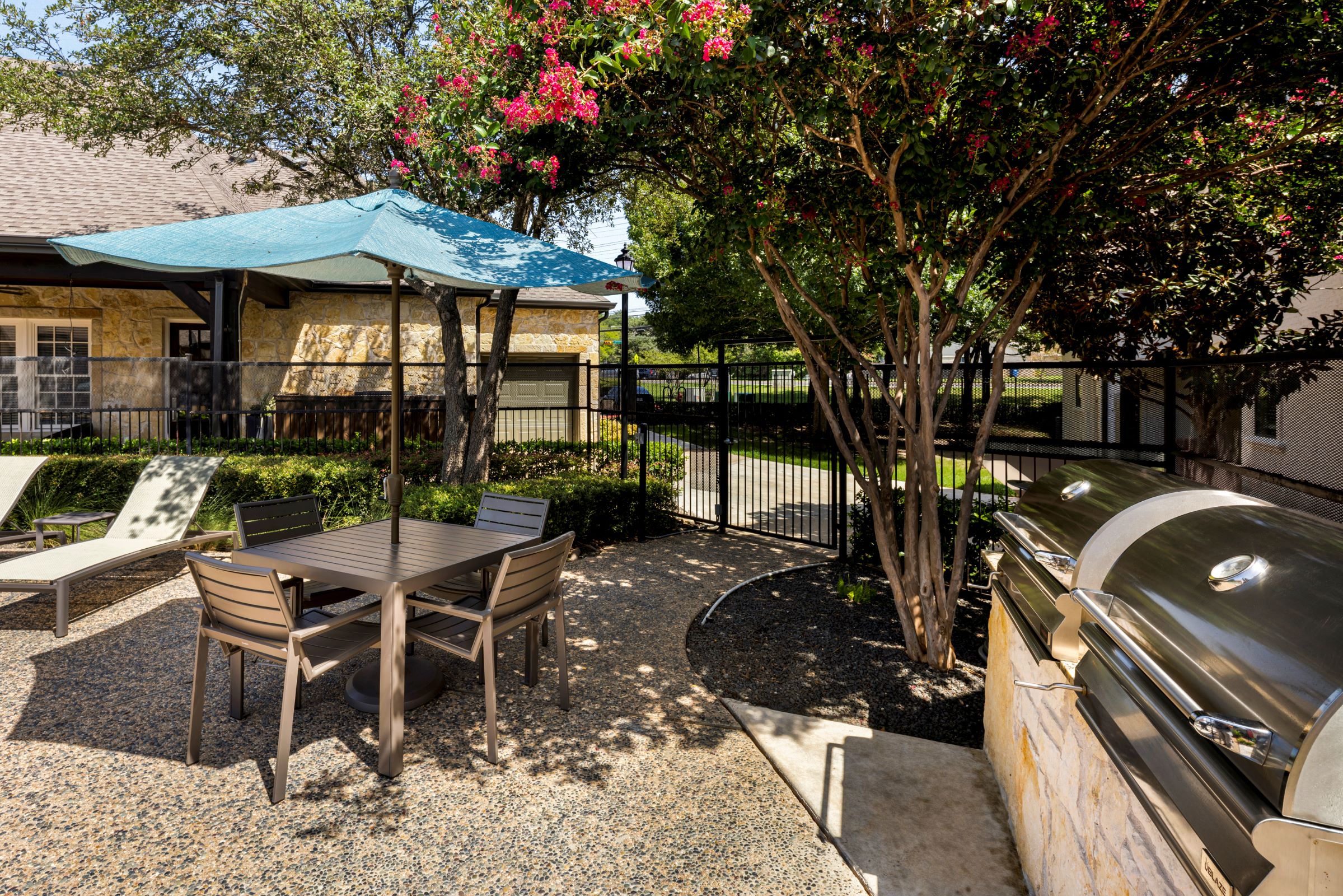Poolside grills with shaded seating at Camden Shadow Brook apartments in Austin, TX 