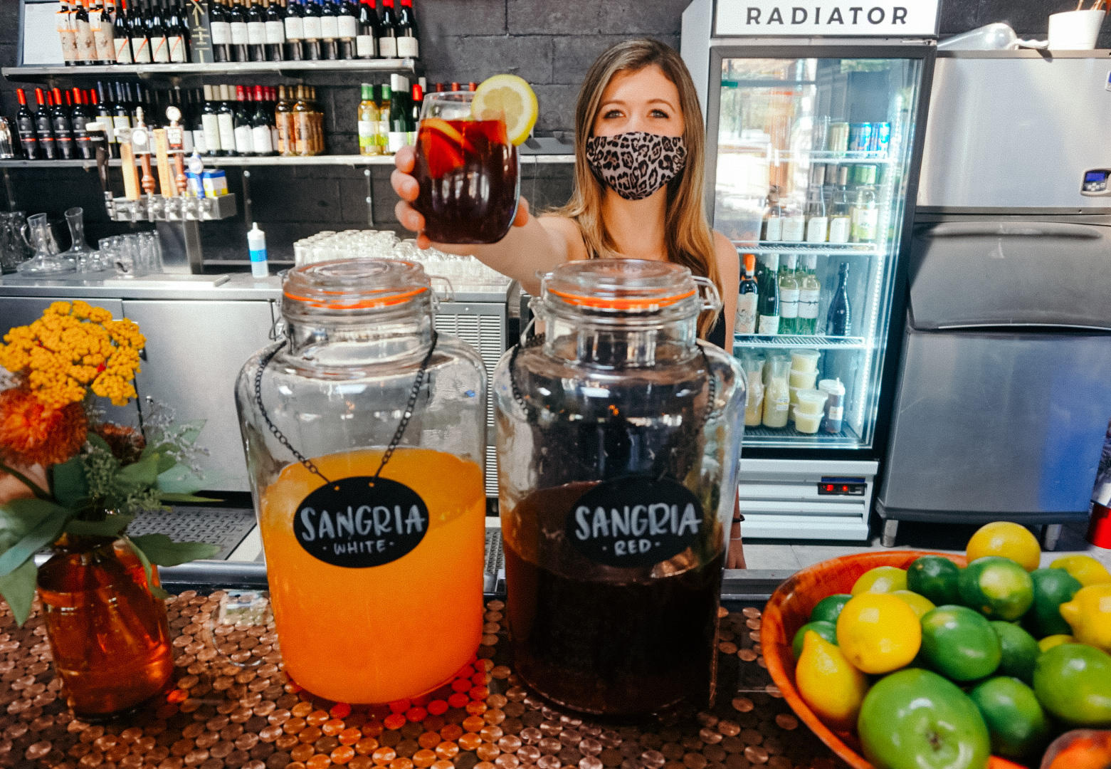 bartender holding up a glass of sangria