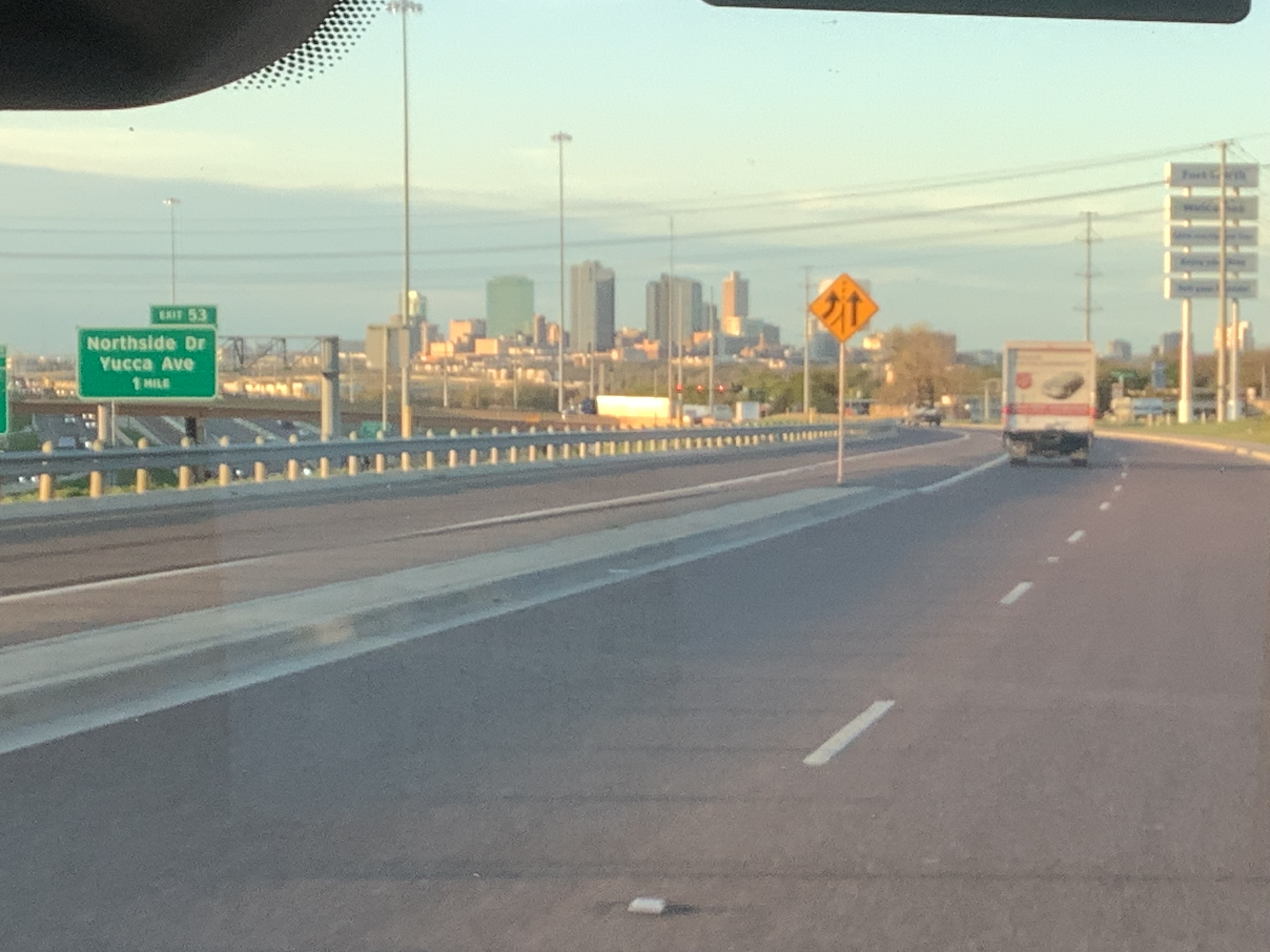 A Tioga Plumbing & Electric vehicle driving into down town Fort Worth Texas.