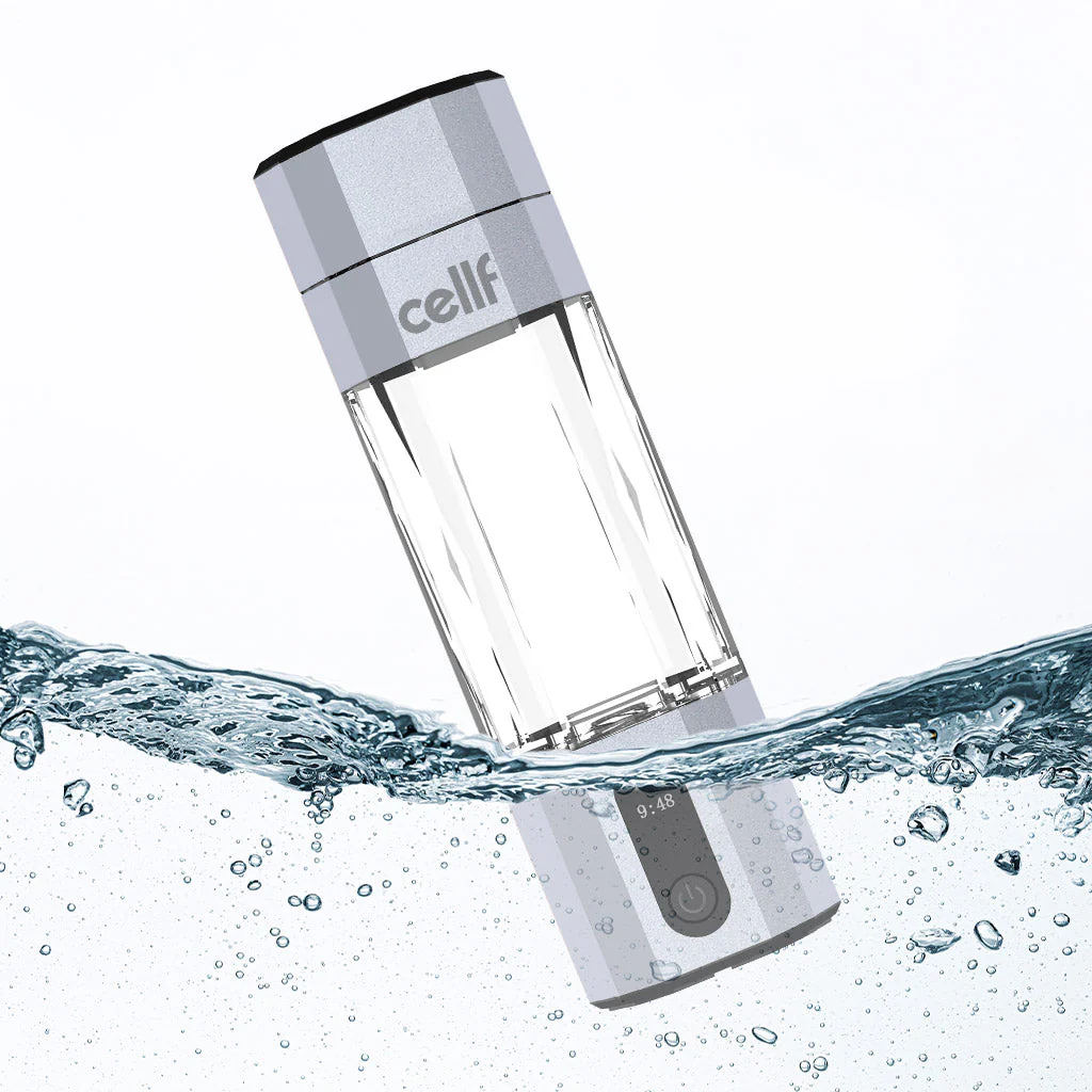 A silver and clear 'cellf' branded hydrogen water bottle is partially submerged in water, with many small bubbles surrounding it. The bottle has a textured grip, a digital display showing '9:48', and a power button icon.