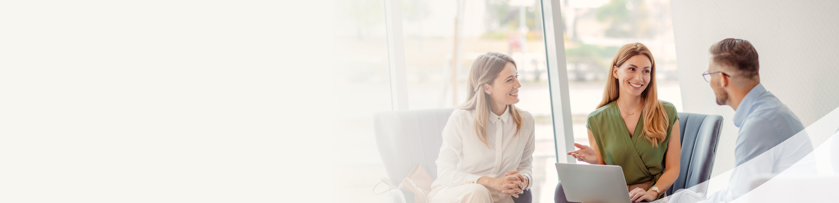 An advisor smiling during a meeting with a client couple.
