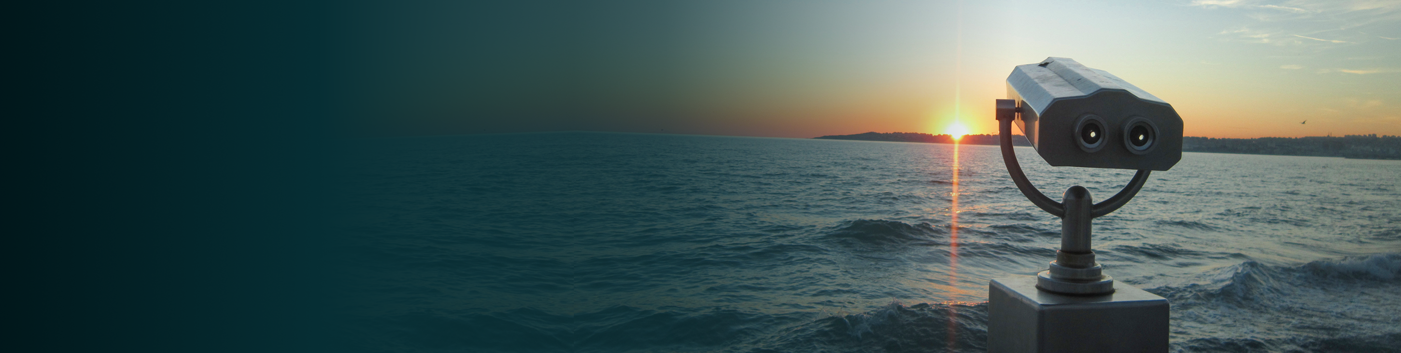 Observation viewer over a wavey body of water at sunset.