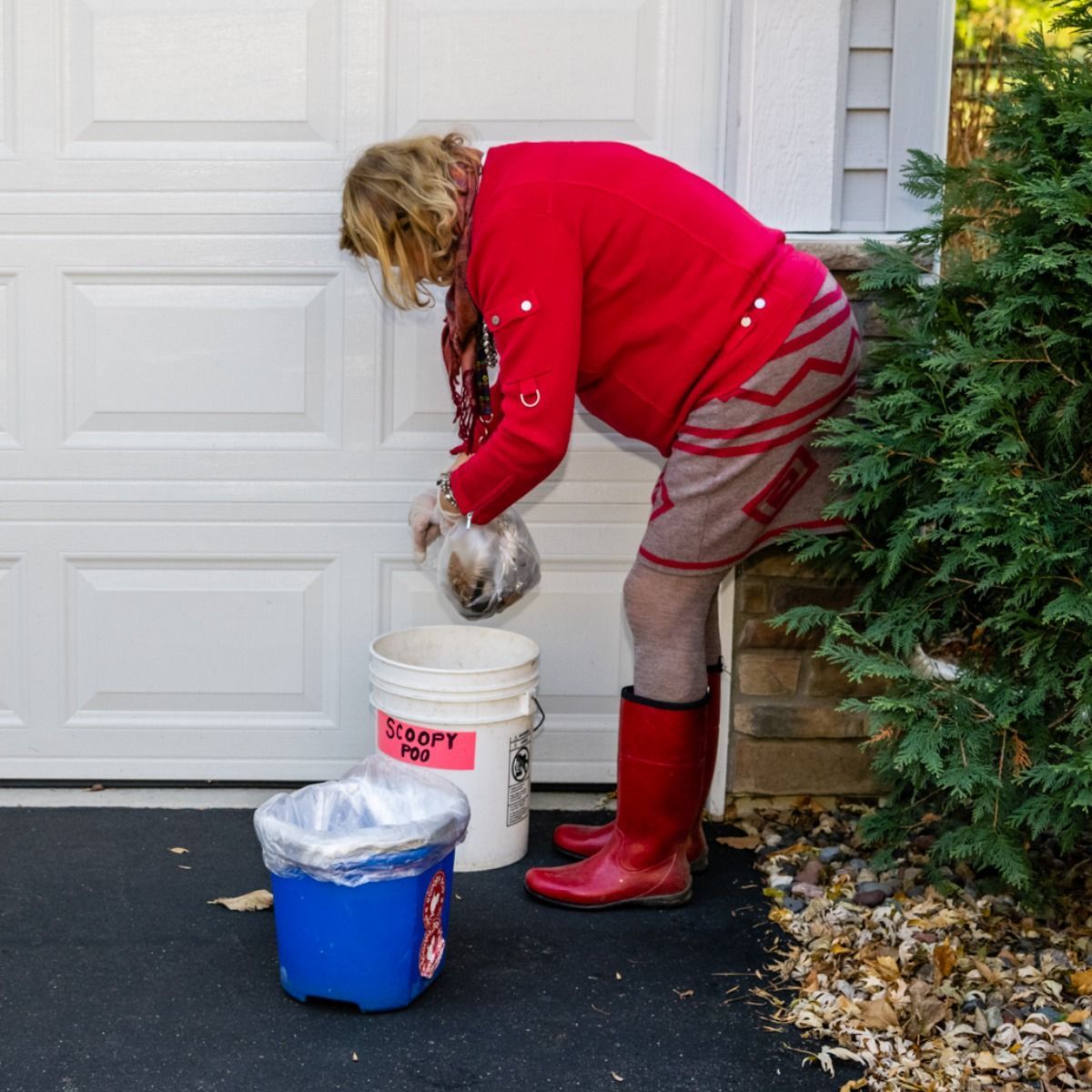 ScoopyPoo team member disposes collected pet waste into a designated container, following responsible sanitation practices while completing professional residential dog waste removal services with care and cleanliness every visit.