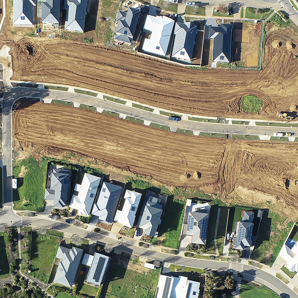 Aerial view of a neighborhood with open lots