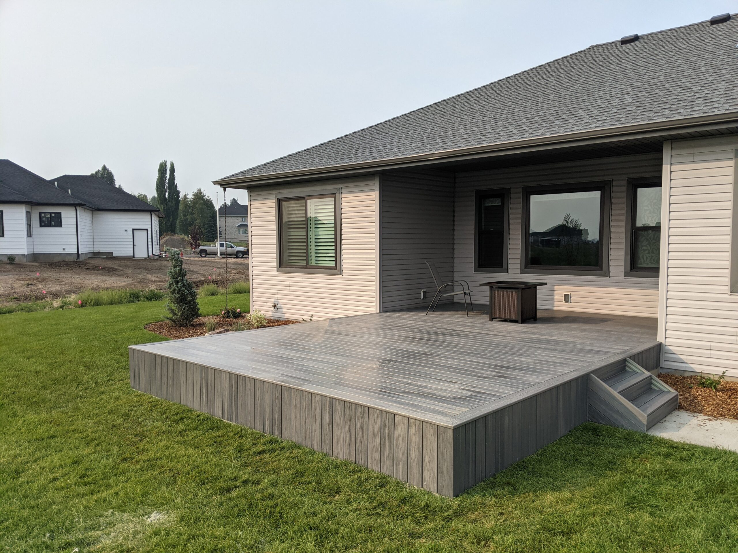 Expand your outdoor living space with this custom deck project by DeckPro LLC, designed to blend rustic charm with modern durability. This build features low-maintenance composite decking and a unique perimeter railing that combines natural wood posts with wire mesh infill panels. The functional design includes extensive built-in bench seating, making it an inviting retreat perfect for relaxing and taking in scenic, natural views.