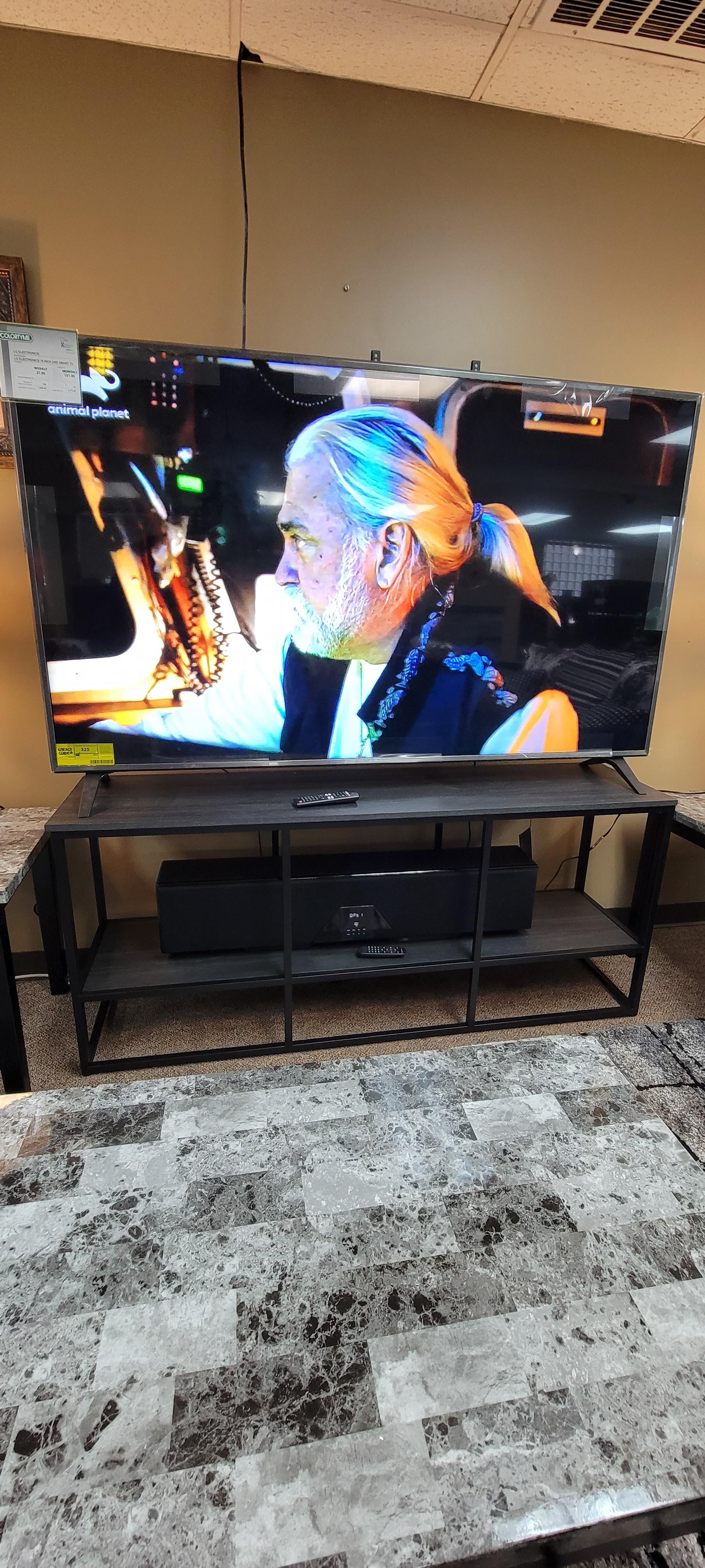 "80 TV combo with stand and sound bar. Living room does not get better than this.