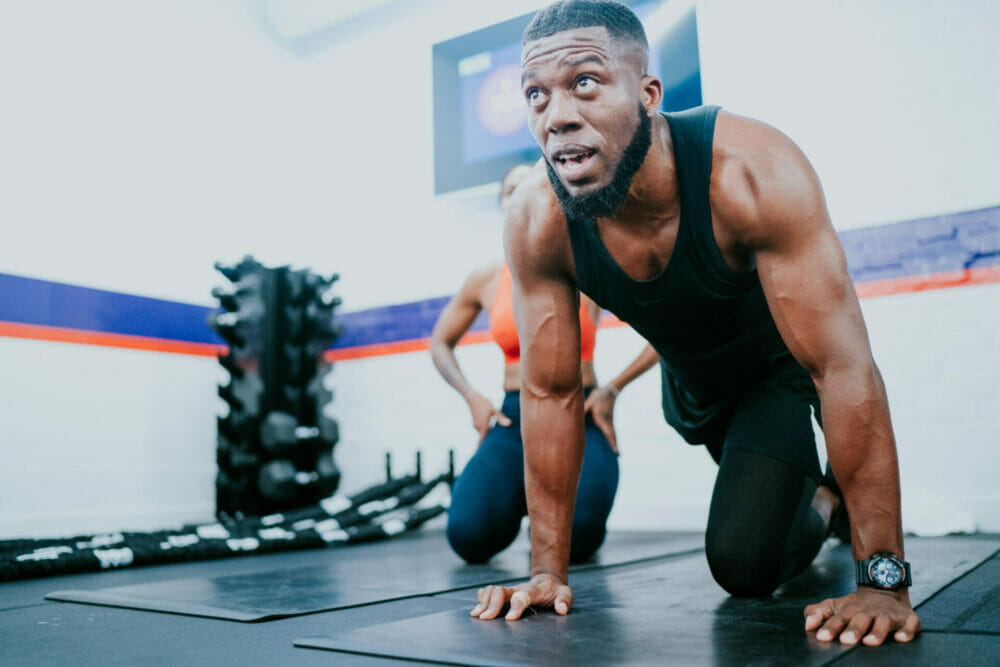 F45 member performing a floor exercise during functional group training. 