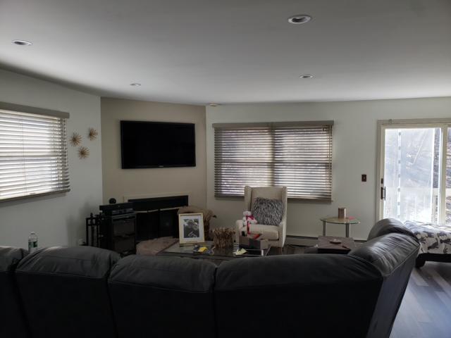 This lovely shady look comes from our Wood Blinds. They make this Ossining living room so comfortable and cozy that we just want to invite friends over to watch the game! #BudgetBlindsOssining #OssiningNY #WoodBlinds #FreeConsultation #WindowWednesday