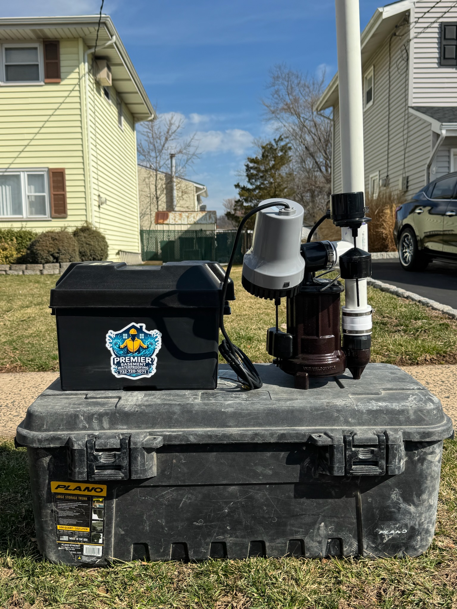 Photo of Premier Basement Waterproofing equipment set up outside a residential home during a basement waterproofing or sump pump service project.