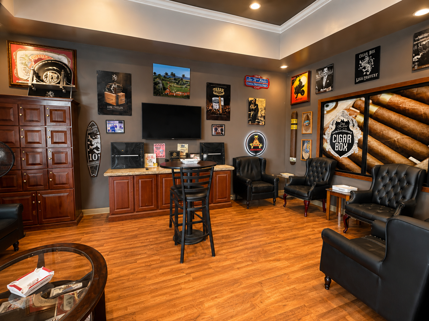 Experience the welcoming atmosphere at Tom Trella's premium cigar lounge, featuring comfortable leather seating, elegant décor, and a spacious customer lounge designed for relaxation. This inviting interior provides the perfect setting to browse premium cigars, socialize, and enjoy a refined in-store experience.