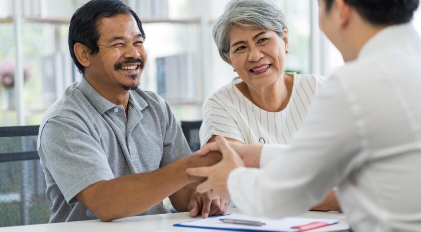 Two seniors talking with a financial professional.
